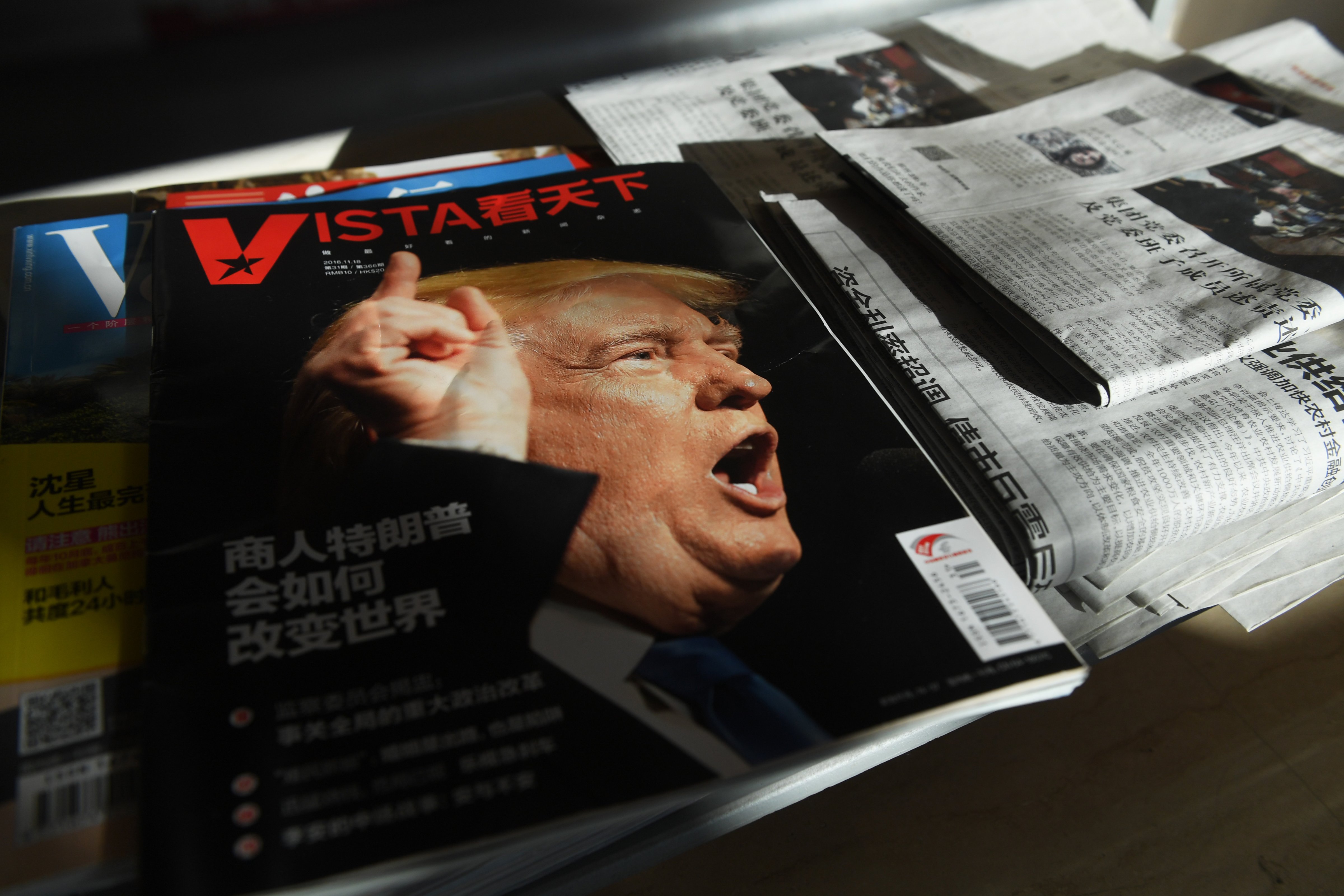 A magazine featuring a front-page story on Donald Trump sits on a magazine rack at a company office in Beijing on Dec. 28, 2016. Chinese media have warned of a potential trade war with the U.S. (Greg Baker—AFP/Getty Images)