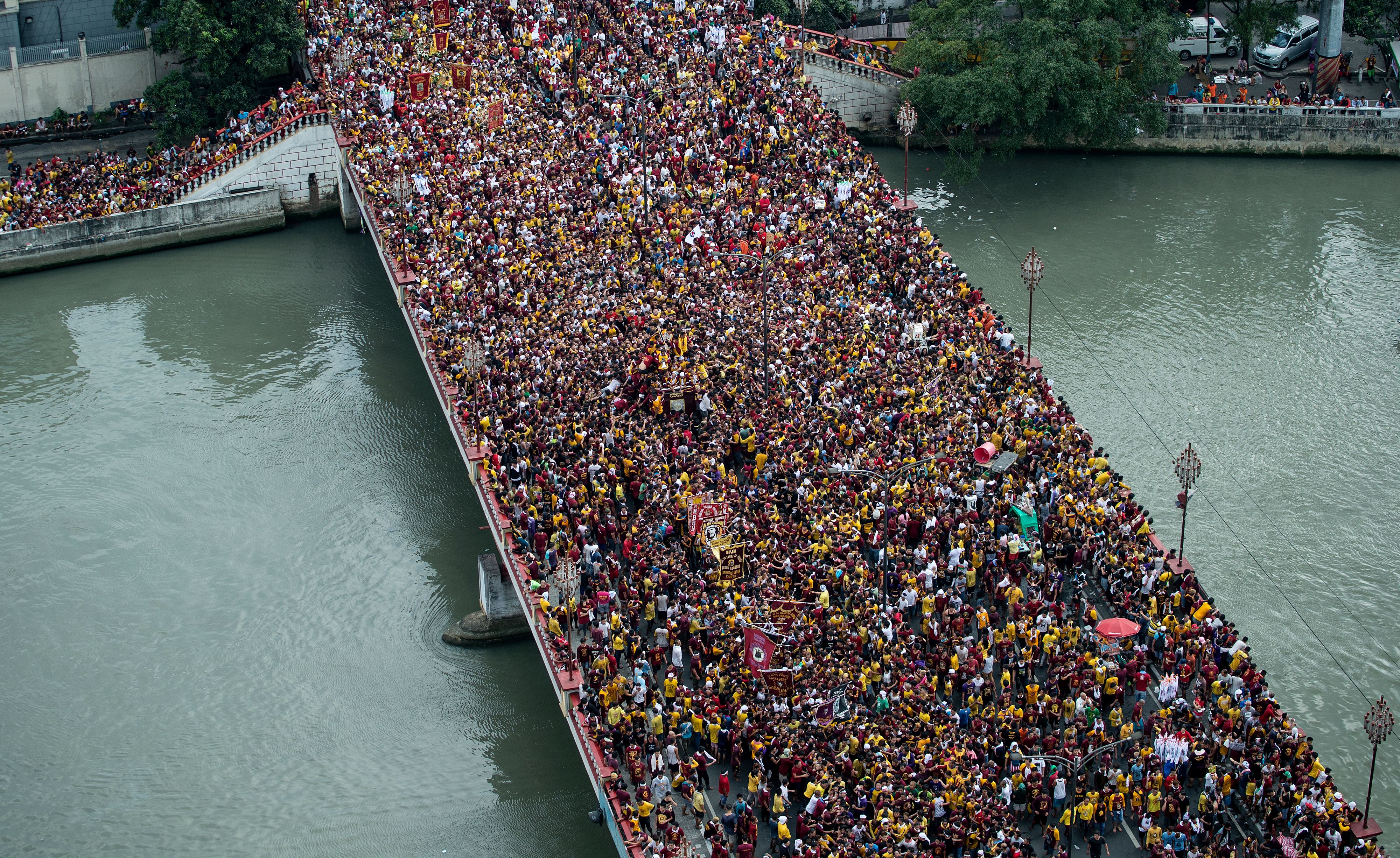 Devotees join the annual procession with the religious icon of the Black Nazarene in Manila on Jan. 9, 2017 (Noel Celis—AFP/Getty Images)