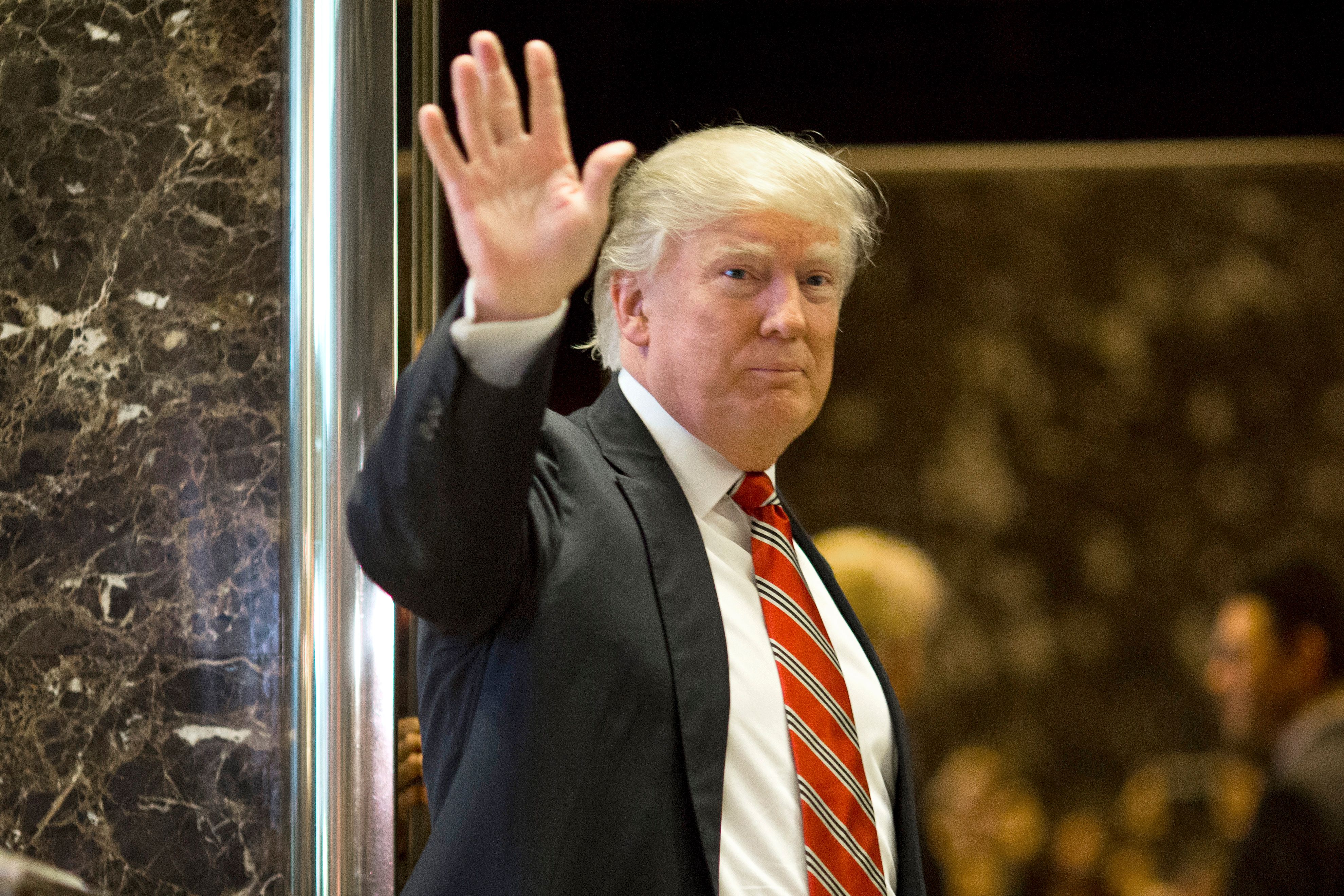US President-elect Donald Trump waves toward the media after meeting Martin Luther King III at Trump Tower in New York City on January 16, 2017. (Dominick Reuter—AFP/Getty Images)