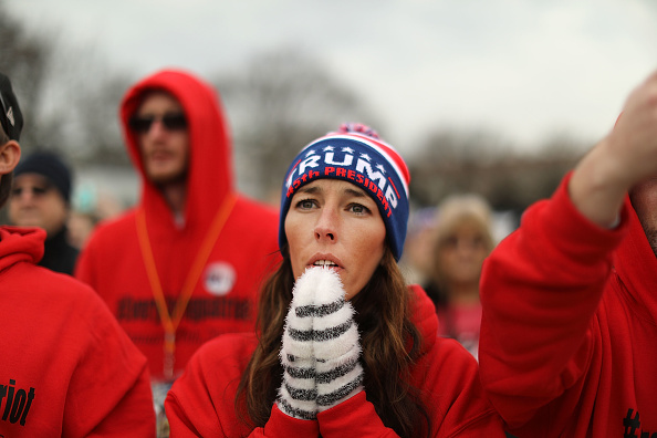 U.S. President Donald Trump supporters pray on the National Mall during the inauguration of US President Donald Trump on January 20, 2017 in Washington, D.C.