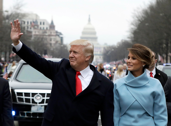 U.S. President Donald Trump waves to supporters as he walks the parade route with first lady Melania Trump after being sworn in at the 58th Presidential Inauguration January 20, 2017 in Washington, D.C. (Pool—Getty Images)