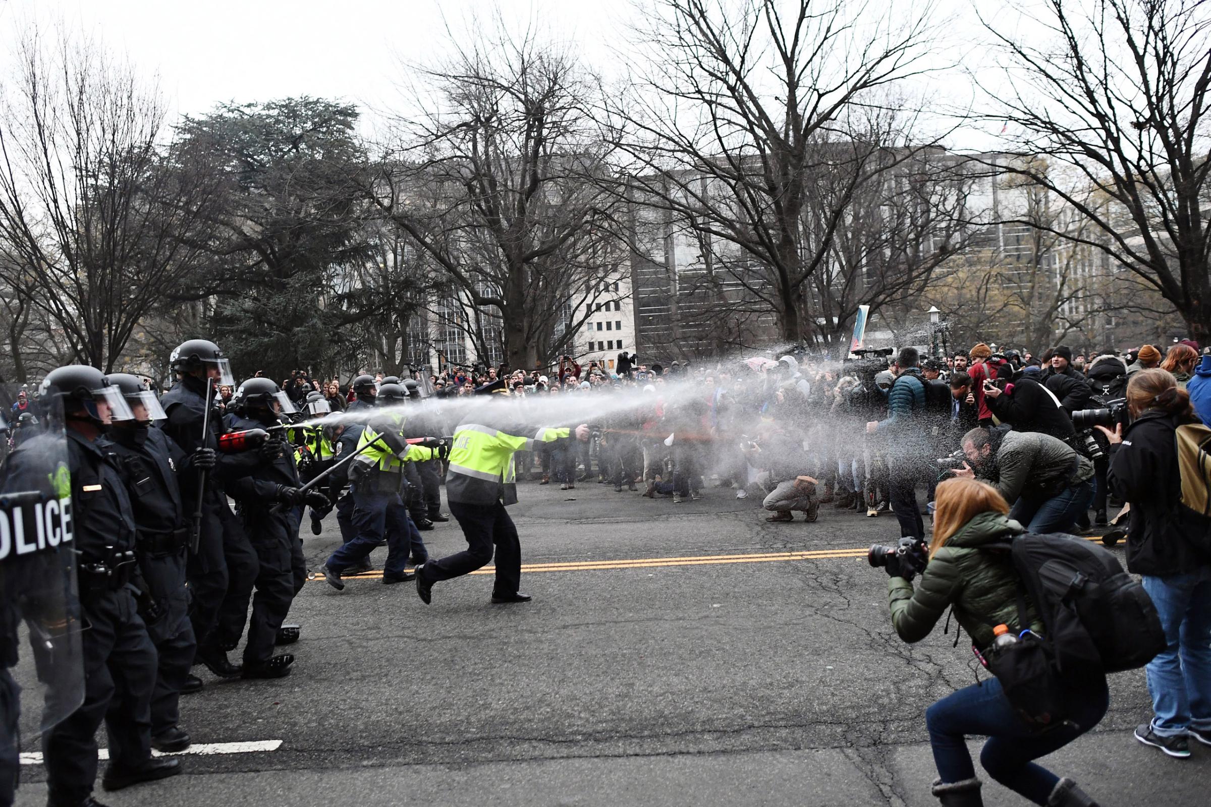 Police pepper spray at anti-Trump protesters during protests in Washington, DC, on Jan. 20, 2017. 