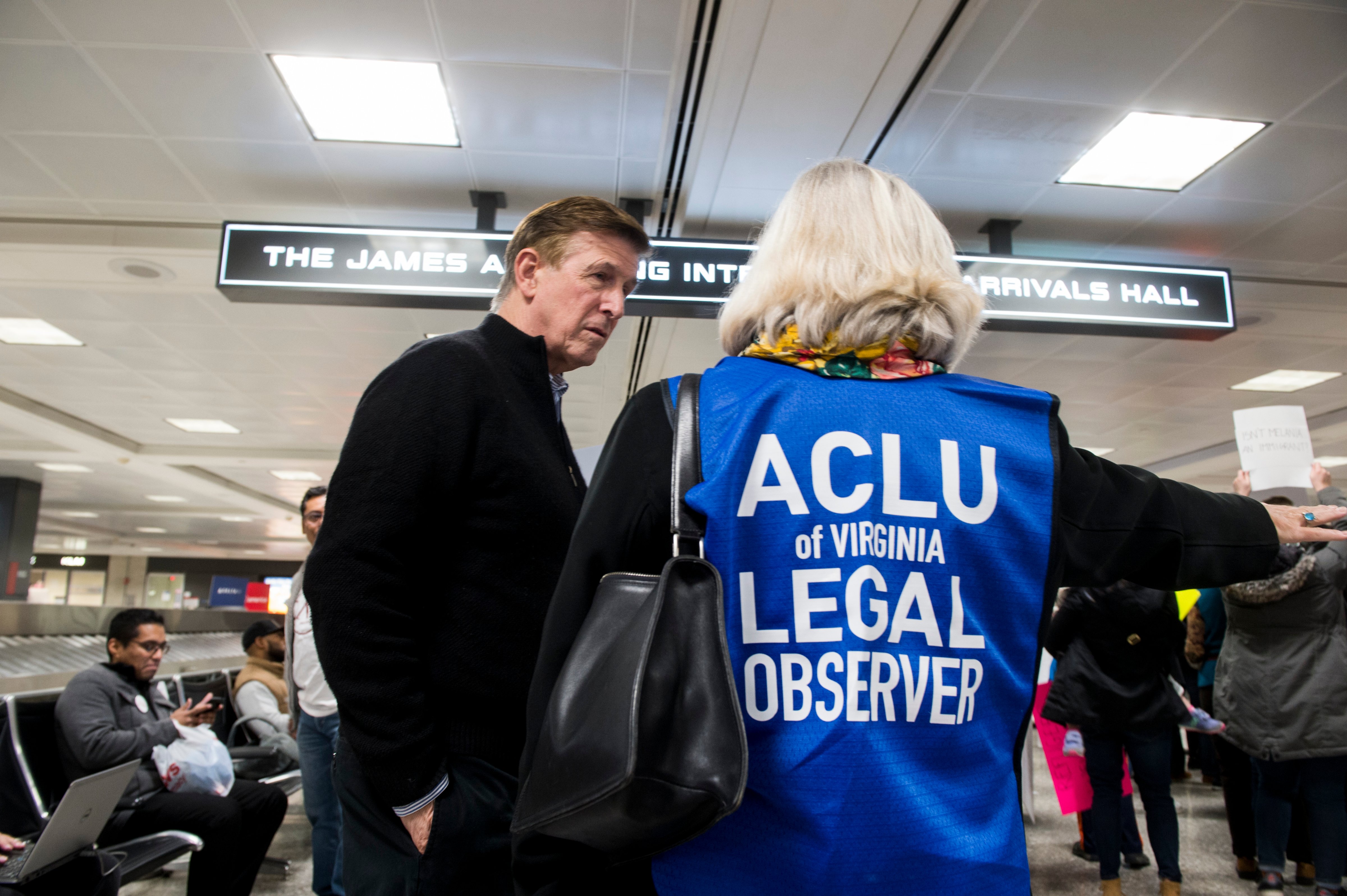 UNITED STATES - JANUARY 29: Rep. Don Beyer, D-Va., speaks with an ACLU legal observer during the protest at Dulles International Airport in Virginia on Sunday, Jan. 29, 2017. Protests erupted at airports around the country following President Trump's executive order restricting travel from several Islamic countries. (Bill Clark/CQ-Roll Call,Inc.)