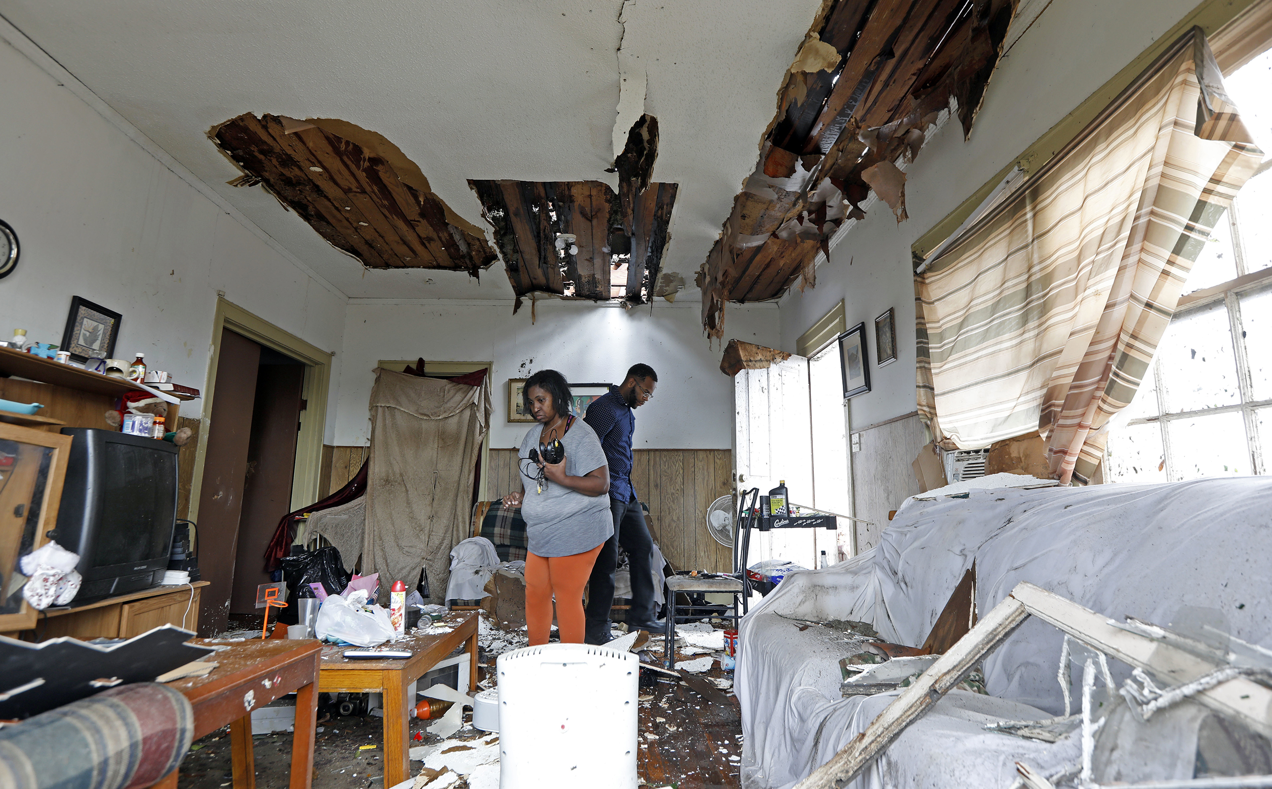 Donna Thompson, and a friend, salvage some of her possessions on Jan. 21, 2017, after a morning tornado ripped her roof off in Hattiesburg, Miss. (Rogelio V. Solis—AP)