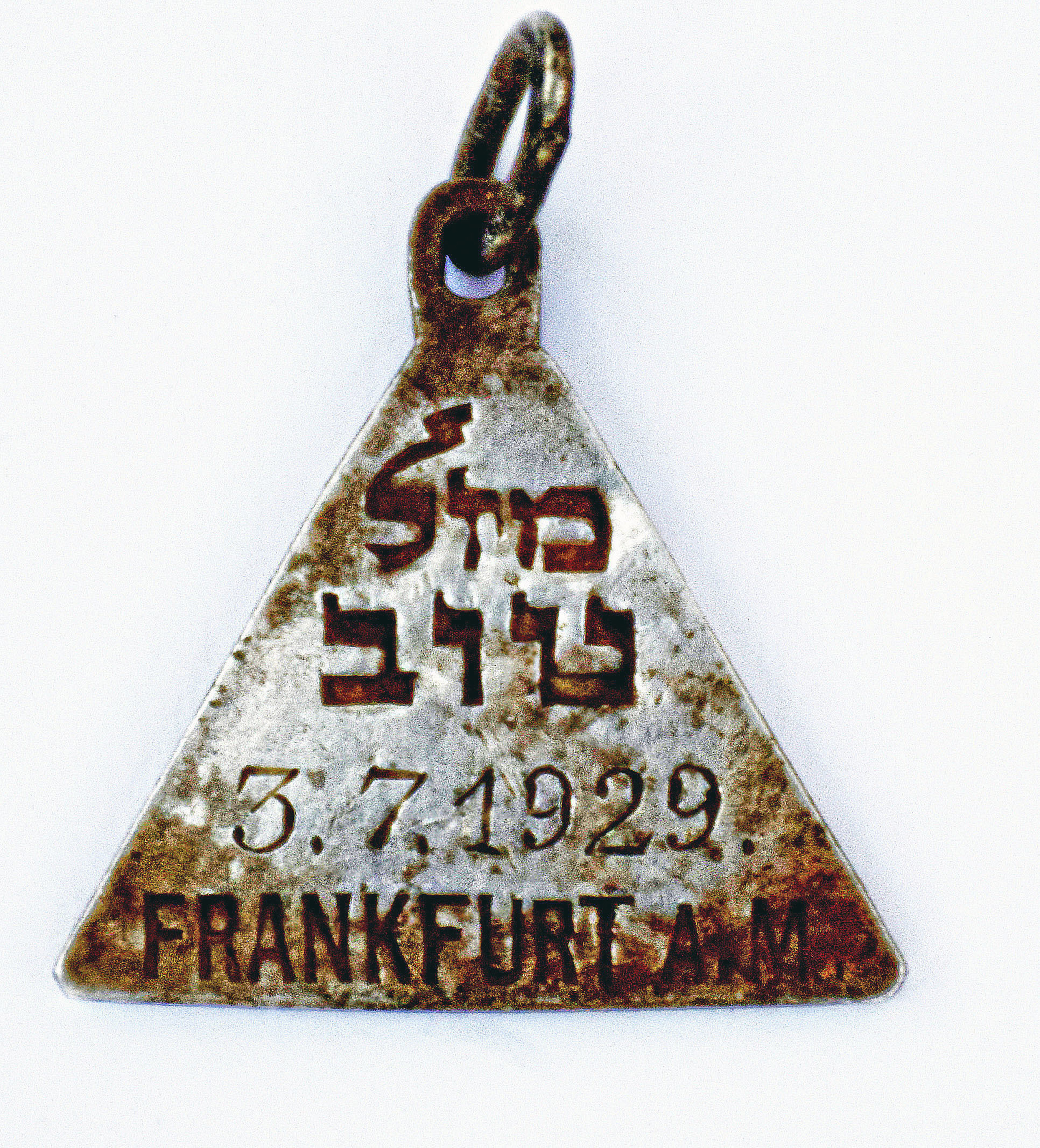 This undated photograph released by the Israel Antiquities Authority shows a pendant that appears identical to one belonging to Anne Frank, Israel's Yad Vashem Holocaust memorial said Sunday. Yad Vashem says it has ascertained the pendant belonged to Karoline Cohn _ a Jewish girl who perished at Sobibor and may have been connected to the famous diarist. Both were born in Frankfurt in 1929 and historians have found no other pendants like theirs. The triangular piece found has the words "Mazal Tov" written in Hebrew on one side along with Cohn's date of birth and the Hebrew letter "heh," an initial for God, as well as three Stars of David on the other. (Yoram Haimi—AP)
