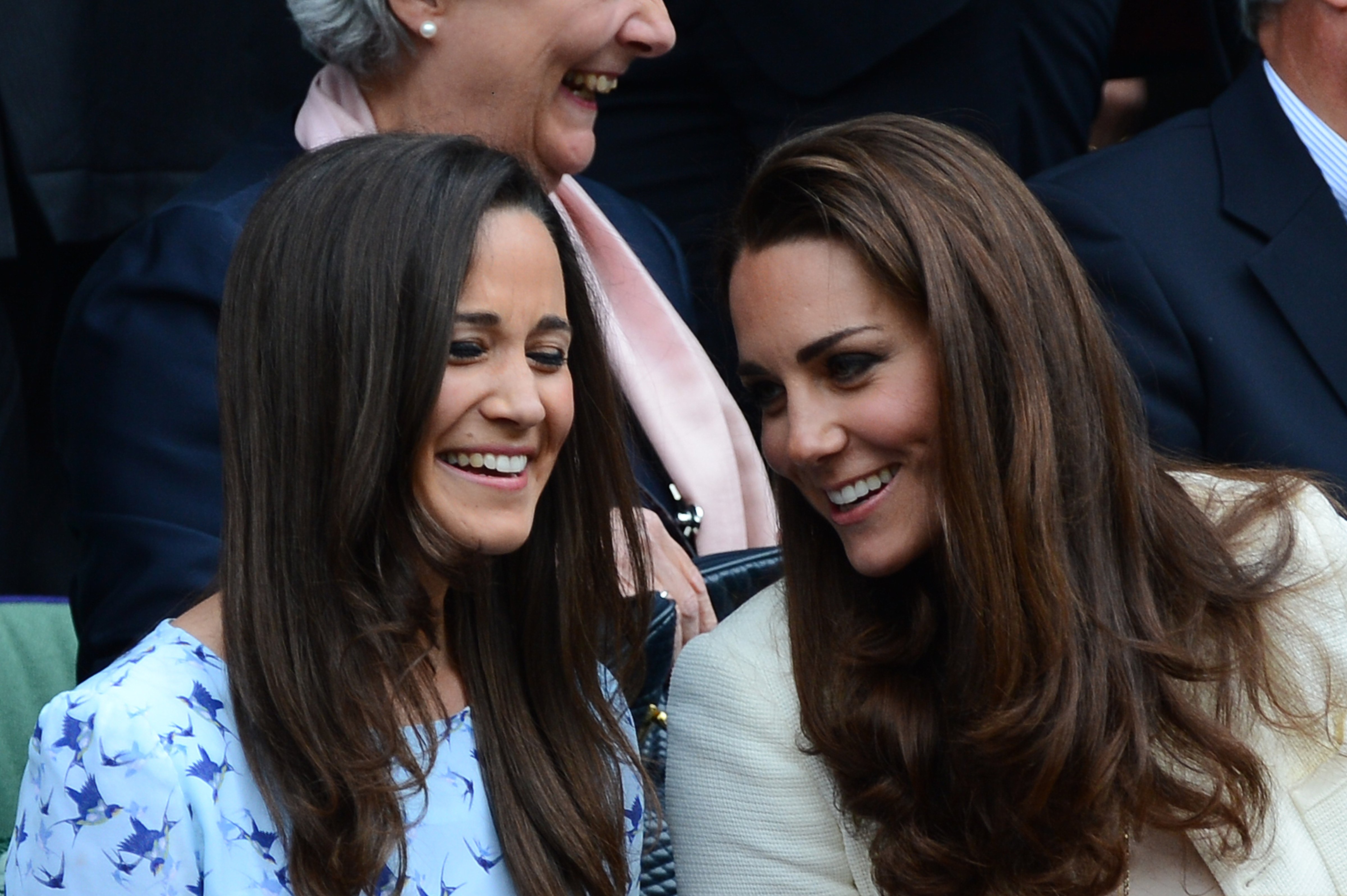 Catherine, Duchess of Cambridge (R) and her sister Pippa Middleton (L) talk in the Royal Box before the men's singles final match between Britain's Andy Murray and Switzerland's Roger Federer on Centre Court on day 13 of the 2012 Wimbledon Championships tennis tournament at the All England Tennis Club in Wimbledon, southwest London, on July 8, 2012. (LEON NEAL—AFP/Getty Images)
