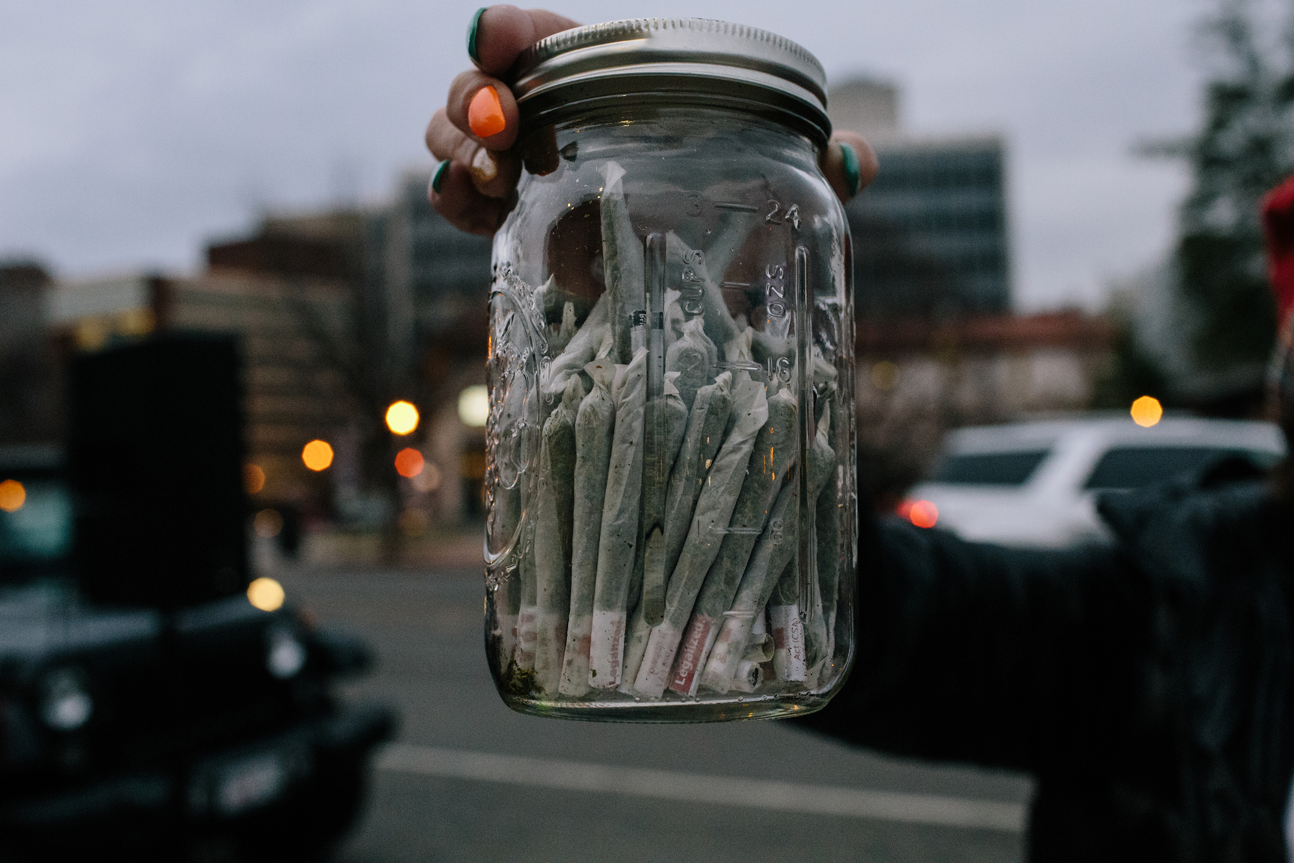 A member of DCMJ holds a jar full of joints near Dupont Circle in Washington on Jan. 20, 2017.