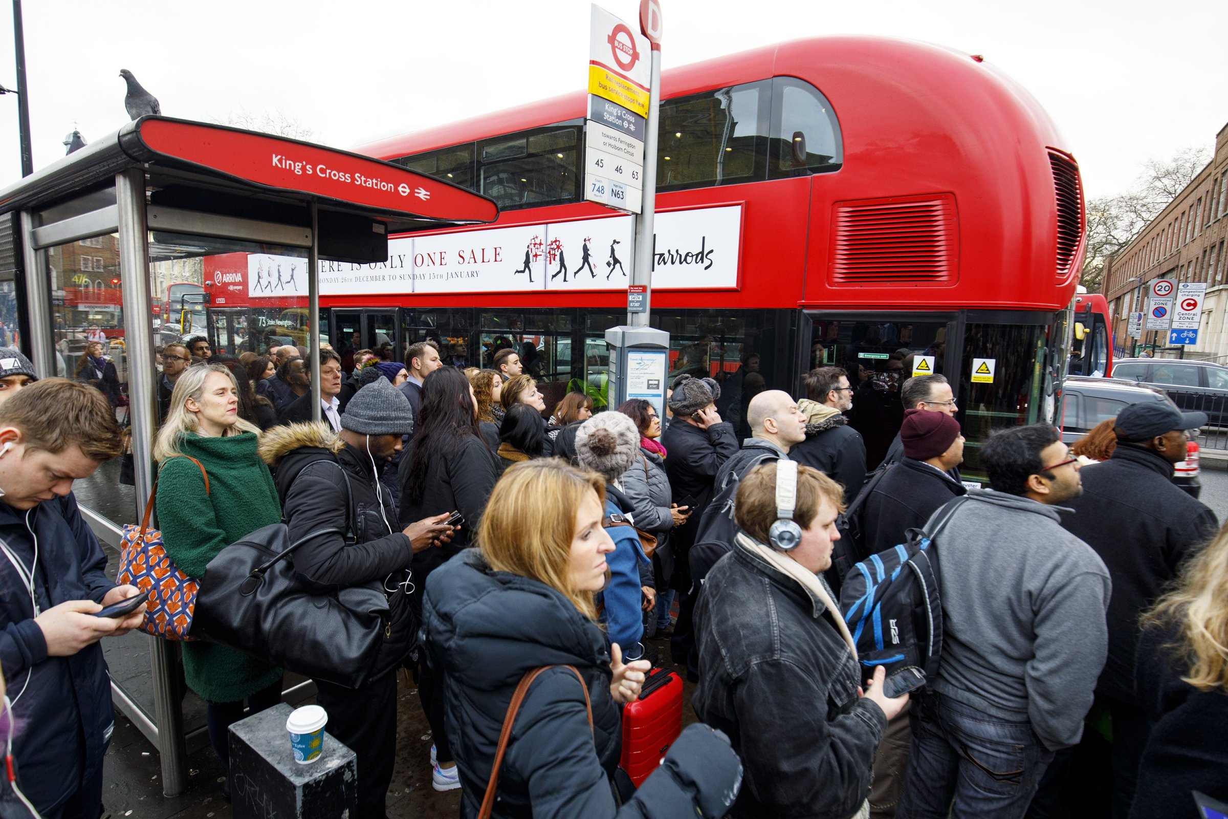 Commuters queue for buses outside King's Cross station as London Underground services are severely disrupted due to members of RMT and TSSA unions start a 24-hour strike action in a dispute over jobs cuts and closed ticket offices on January 9, 2017.