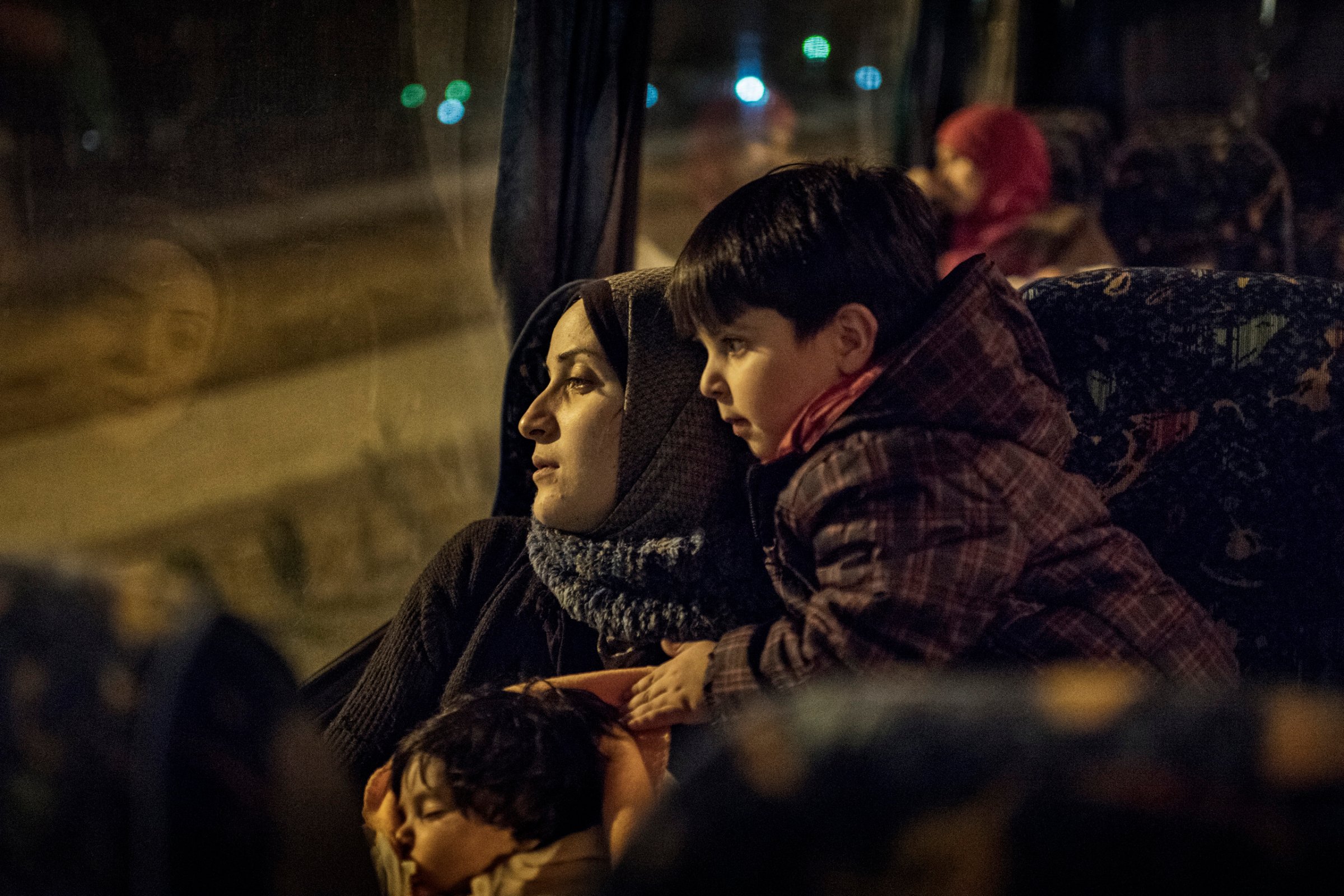 Taimaa Abazli, a Syrian refugee, with her baby Heln and son Wael, take an overnight bus to Athens, where they will learn which country will grant them asylum, Jan. 19, 2017.Taimaa Abazli, a Syrian refugee, with her baby Heln and son Wael, on a 10-hour bus ride from Thessaloniki to Athens where they await news about their placement in Europe.