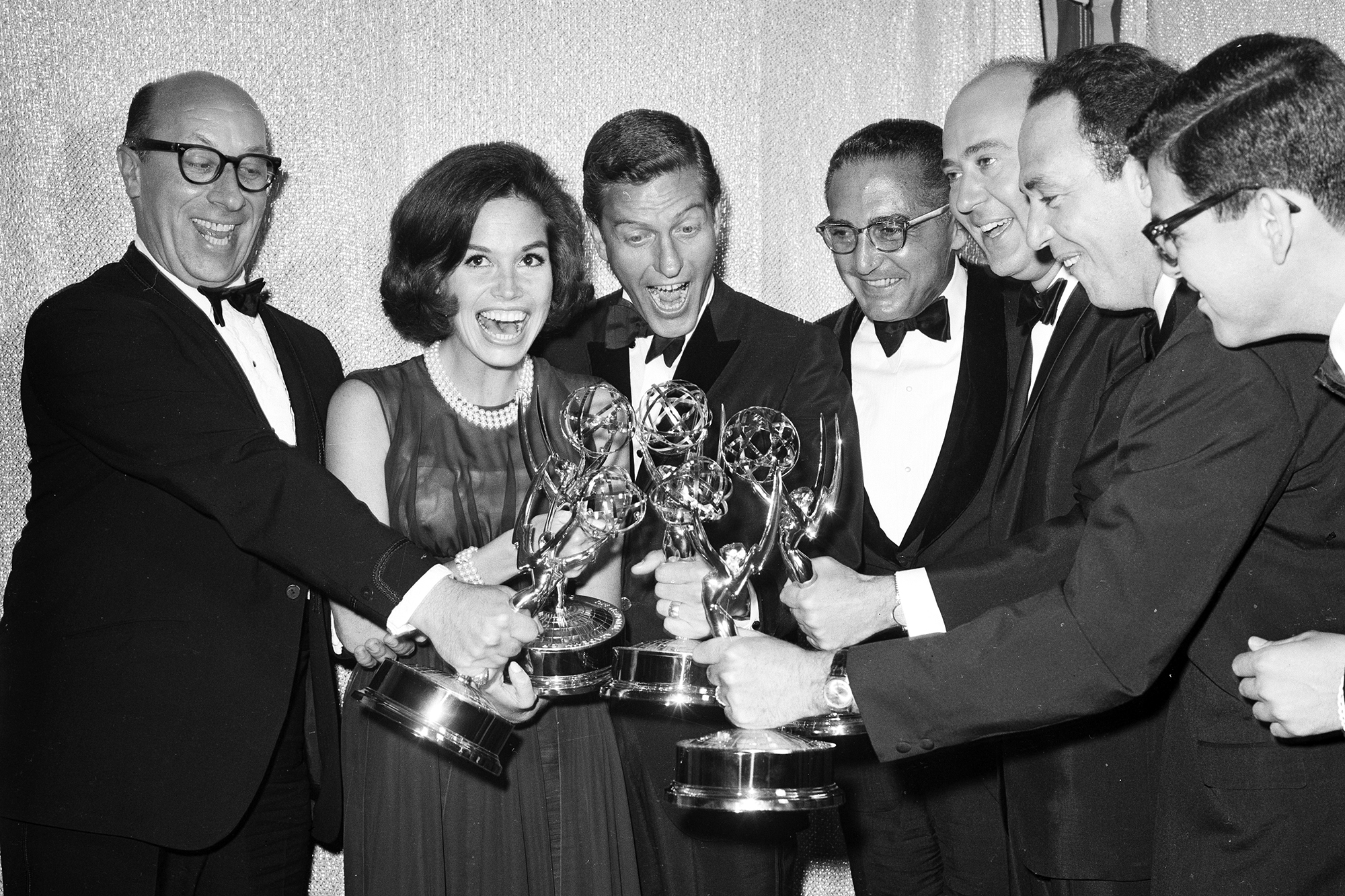 Mary Tyler Moore poses with co-stars of The Dick Van Dyke Show after receiving Emmy Awards c. 1962 in Los Angeles.