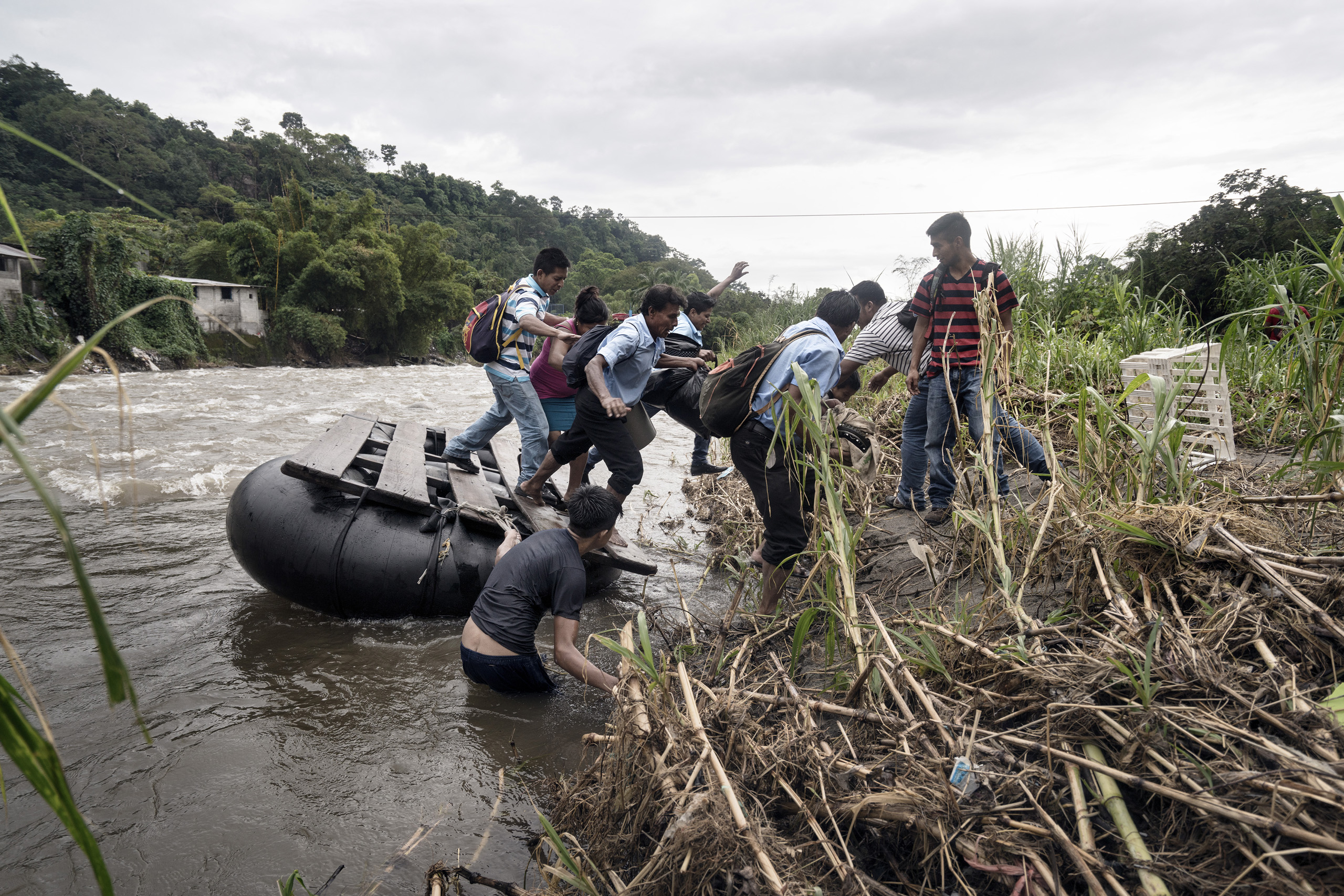 A group of undocumented Central American migrants rafting across the Suchiate River, which is the border between Mexico and Guatemala, illegally entering Mexico near the town of Talismàn. Chiapas, Mexico. Sept. 21, 2016.