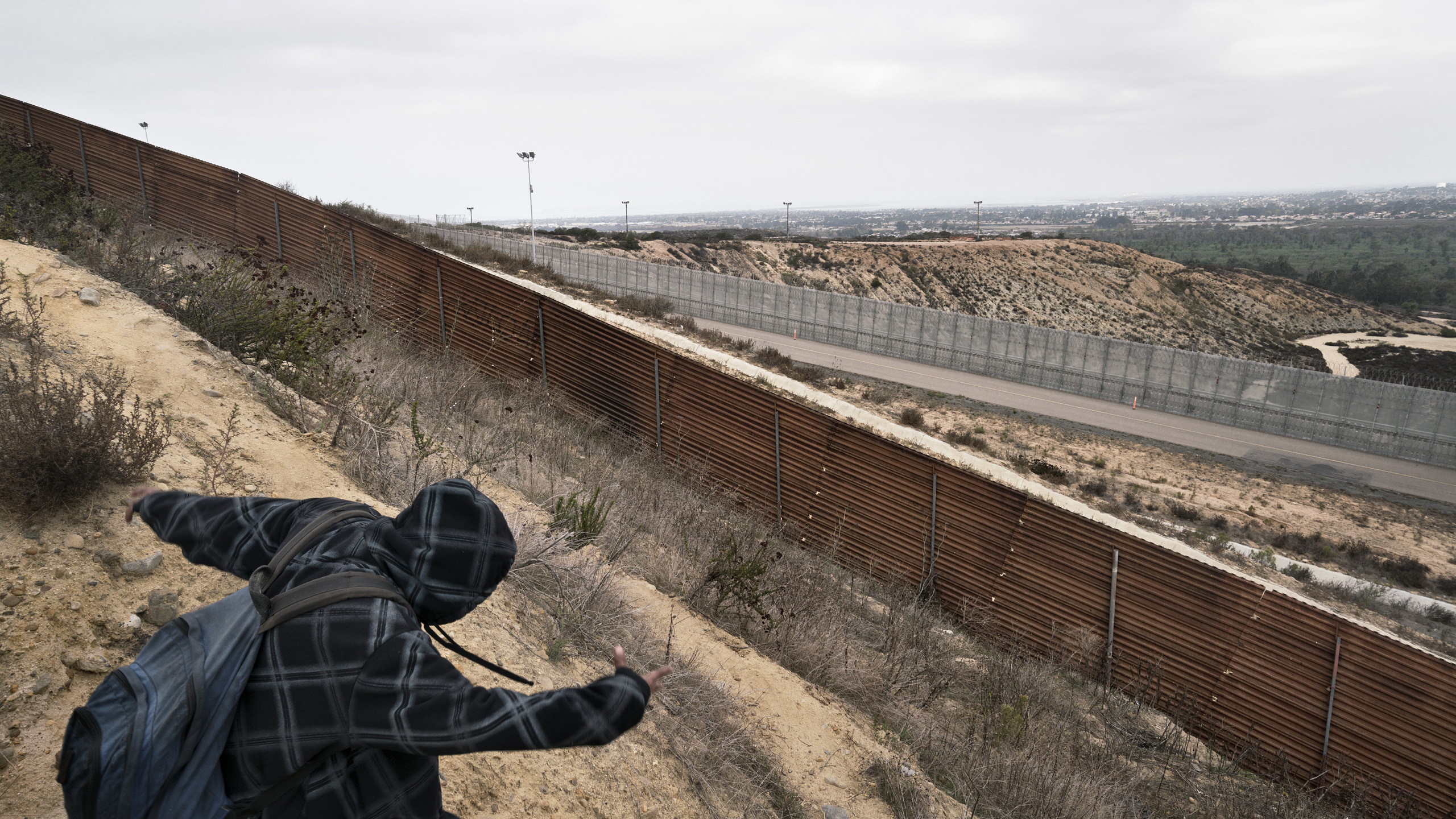 Along the border between Mexico and the U.S. a Salvadorian migrant is looking for a way to cross the border. Tijuana, Baja California, Mexico. Oct. 11, 2016.