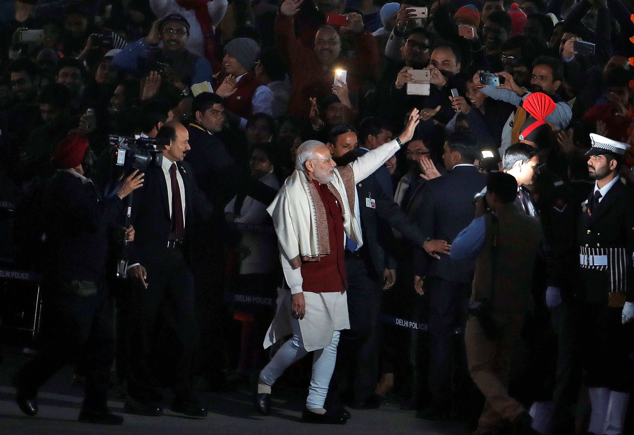 India's Prime Minister Narendra Modi waves as he leaves the Beating the Retreat ceremony in New Delhi