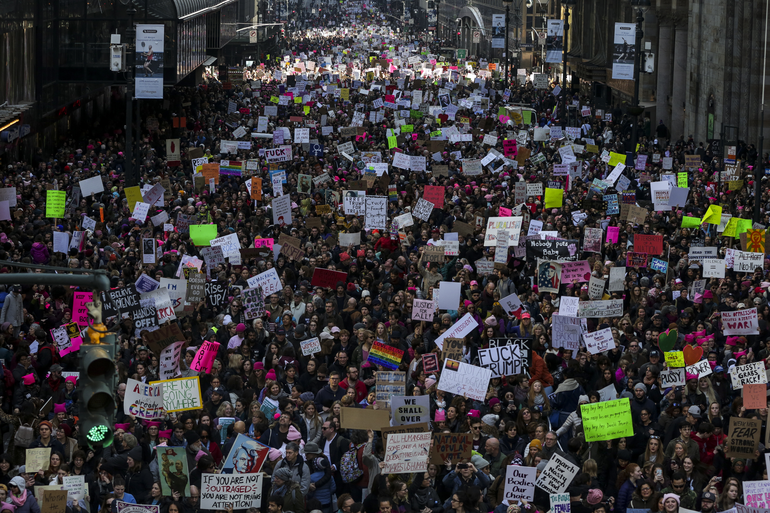 Demonstrators hold signs and march toward Trump Tower on Jan. 21, 2017. (Jeenah Moon—Bloomberg/Getty Images)