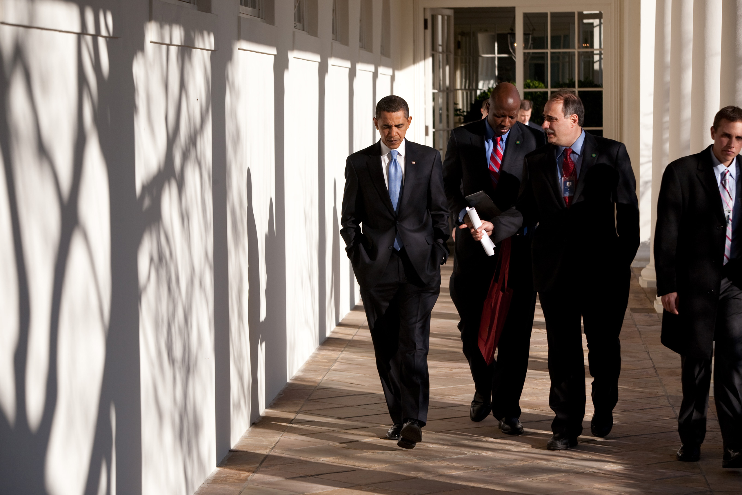 President Barack Obama walks on the Colonnade with David Axelrod  and Reggie Love (c) on his first day in office on Jan. 21, 2009.