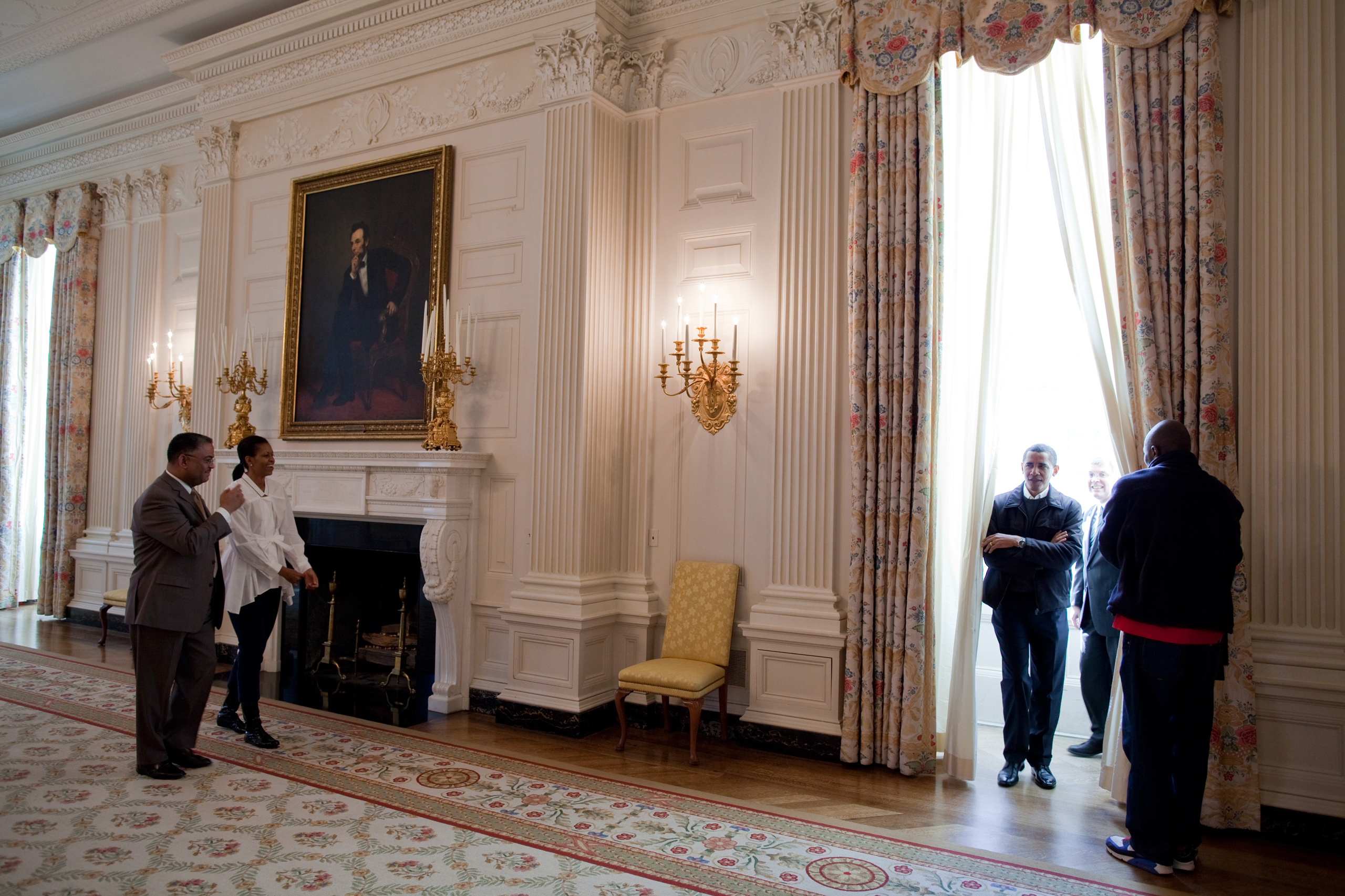 President Barack Obama and First Lady Michelle Obama tour the State Dining Room with White House Chief Usher Admiral Stephen  Steve  Rochon, left; Curator William  Bill  Allman and Personal Aide Reggie Love, right, on Jan. 24, 2009.