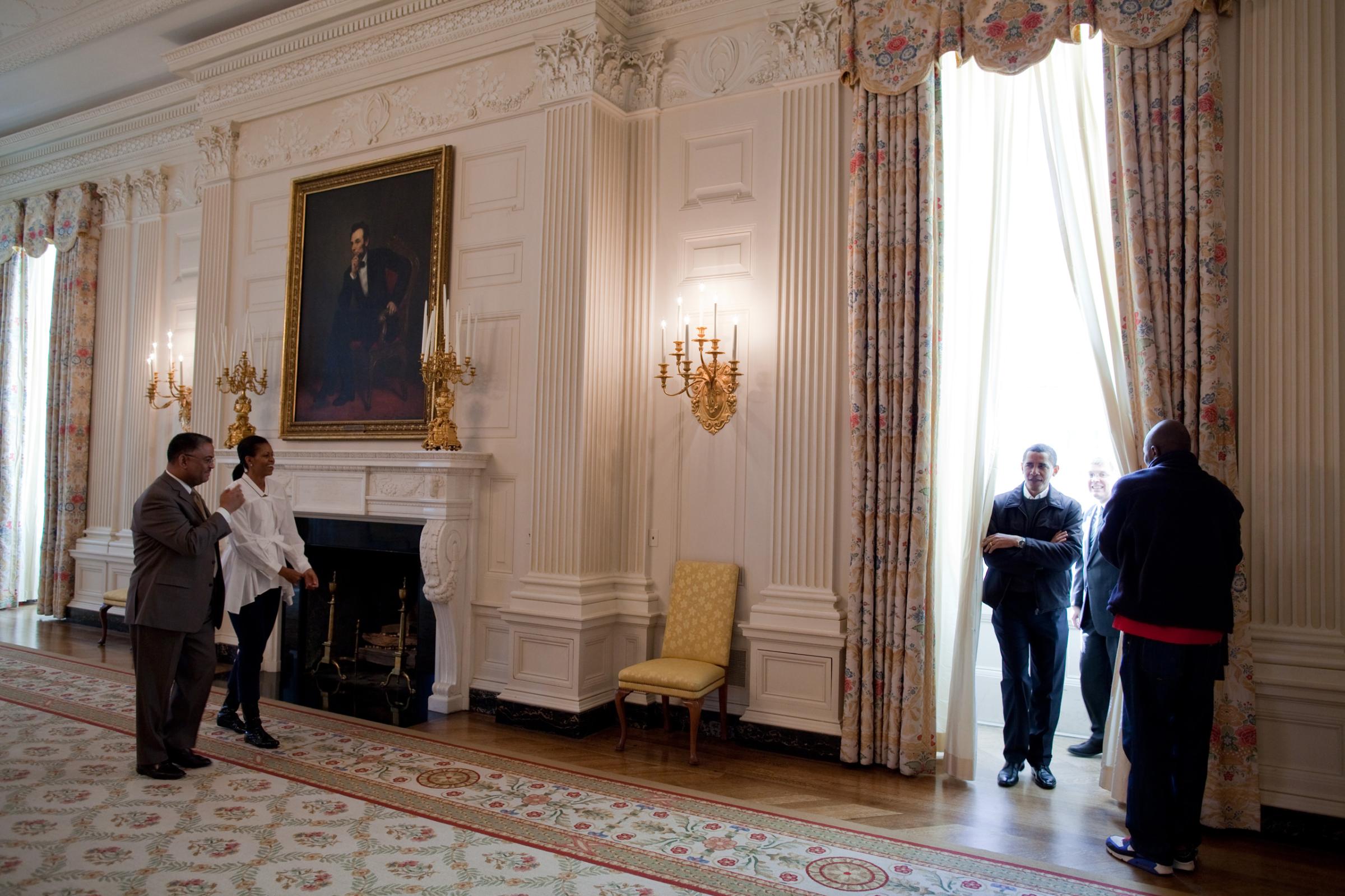 President Barack Obama and First Lady Michelle Obama tour the State Dining Room with White House Chief Usher Admiral Stephen "Steve" Rochon, left; Curator William "Bill" Allman and Personal Aide Reggie Love, right, on Jan. 24, 2009.