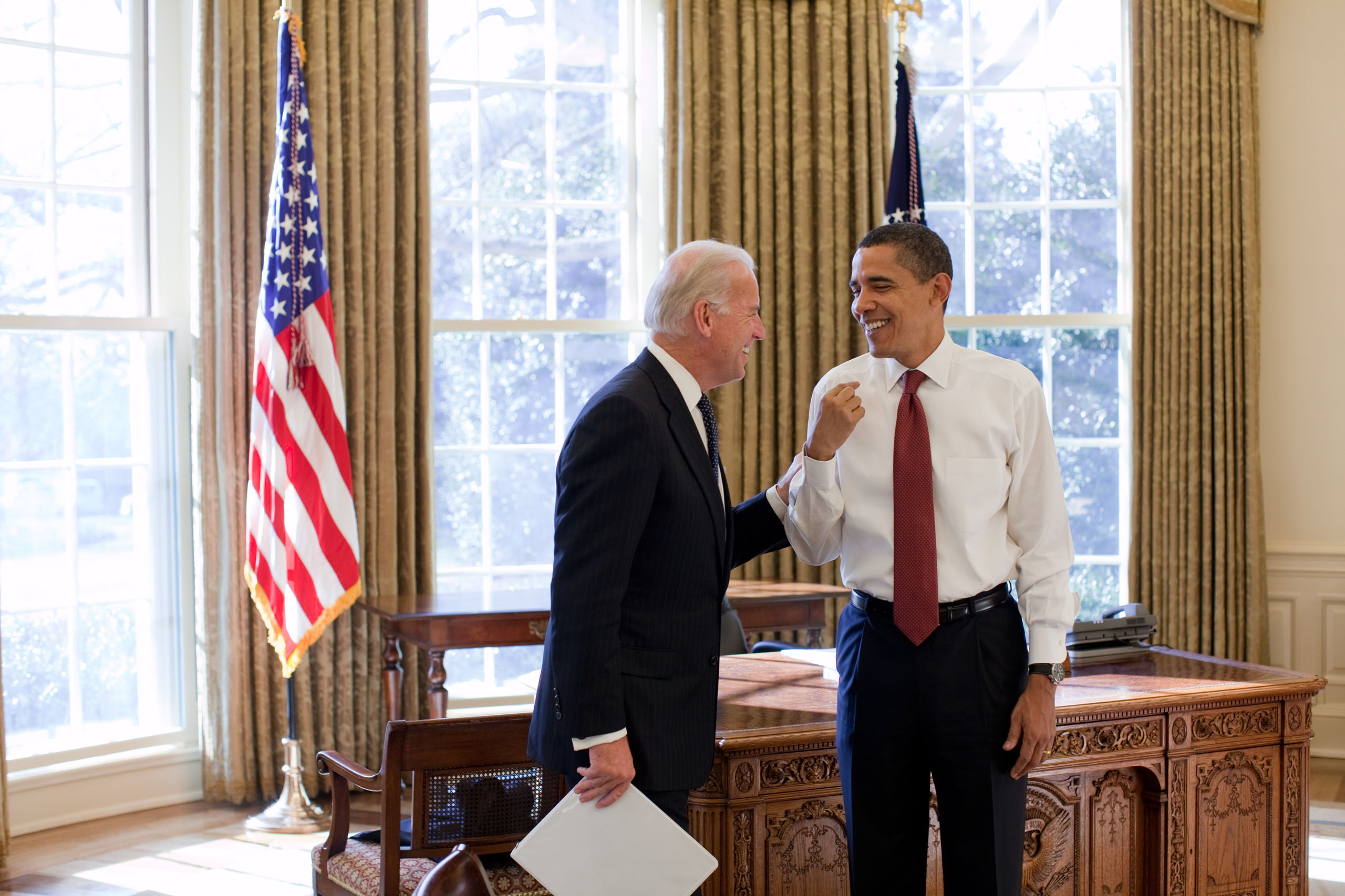 President Barack Obama and Vice President Joe Biden laugh together in the Oval Office on Jan. 22, 2009.