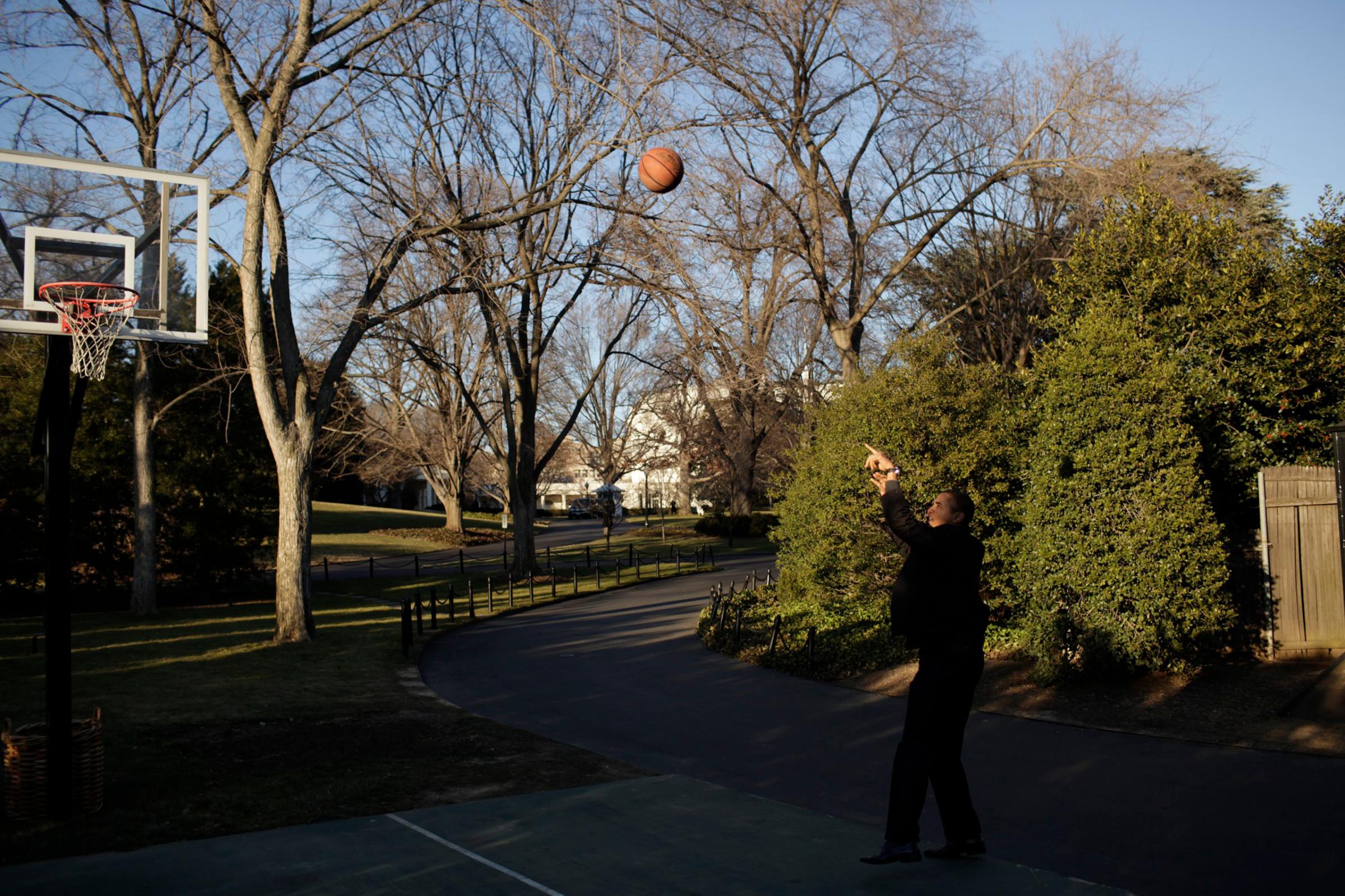 President Barack Obama shpts a basketball during a historical tour of the White House on Jan 24, 2009.
