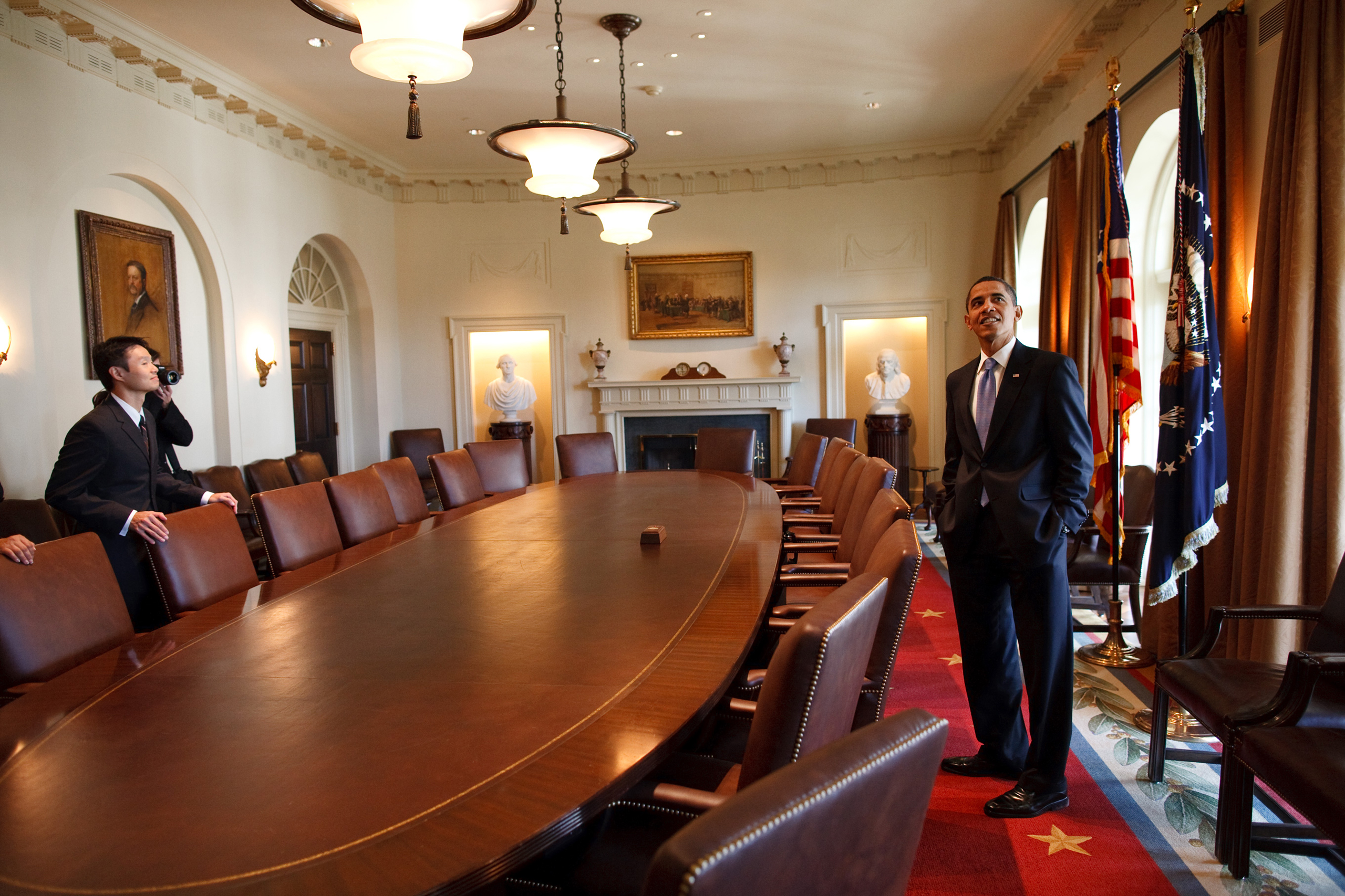 President Barack Obama surveys the Cabinet room with family members while touring the White House on his first day in office.