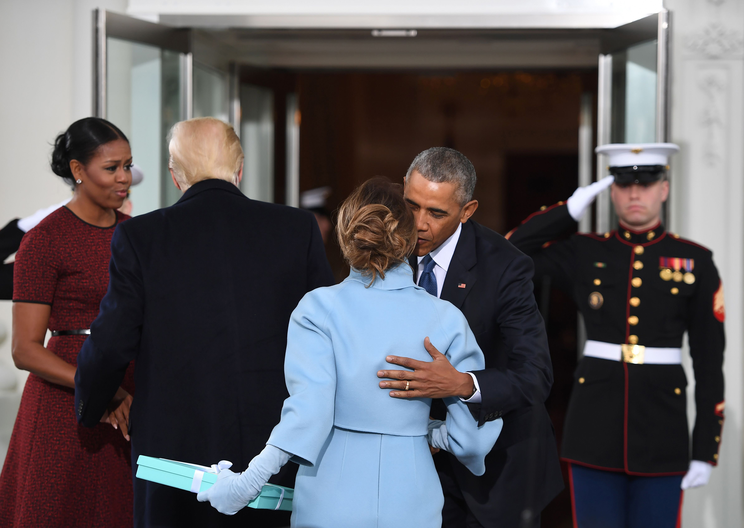 Melania Trump, bearing a gift from Tiffany &amp; Co., greets President Obama before President Trump's swearing-in ceremony. (Jim Watson—AFP/Getty Images)