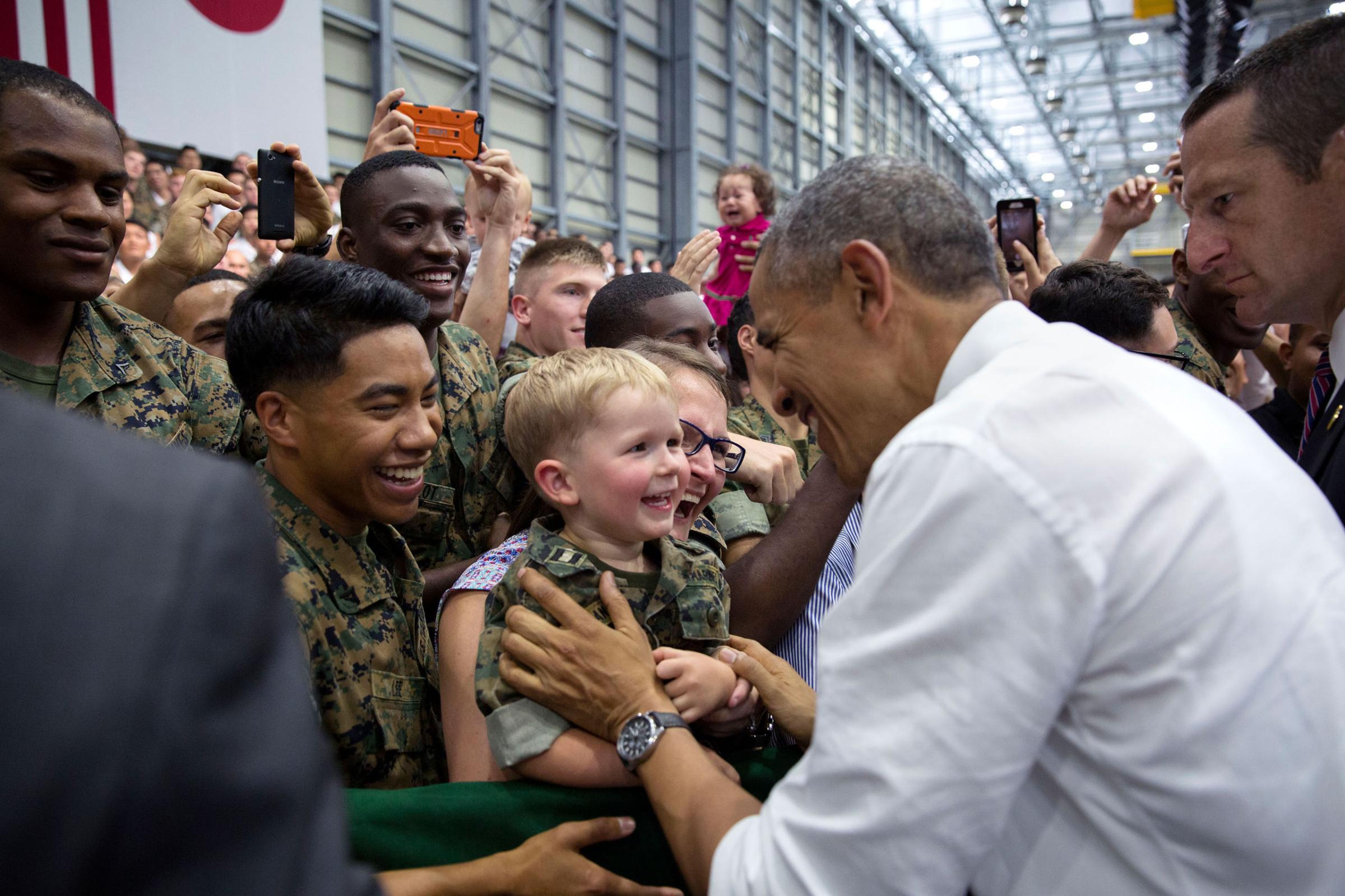 President Barack Obama gets a smile from a young boy as he greets audience members after remarks at Marine Corps Air Station Iwakuni, Japan, May 27, 2016. (Official White House Photo by Pete Souza)This official White House photograph is being made available only for publication by news organizations and/or for personal use printing by the subject(s) of the photograph. The photograph may not be manipulated in any way and may not be used in commercial or political materials, advertisements, emails, products, promotions that in any way suggests approval or endorsement of the President, the First Family, or the White House.