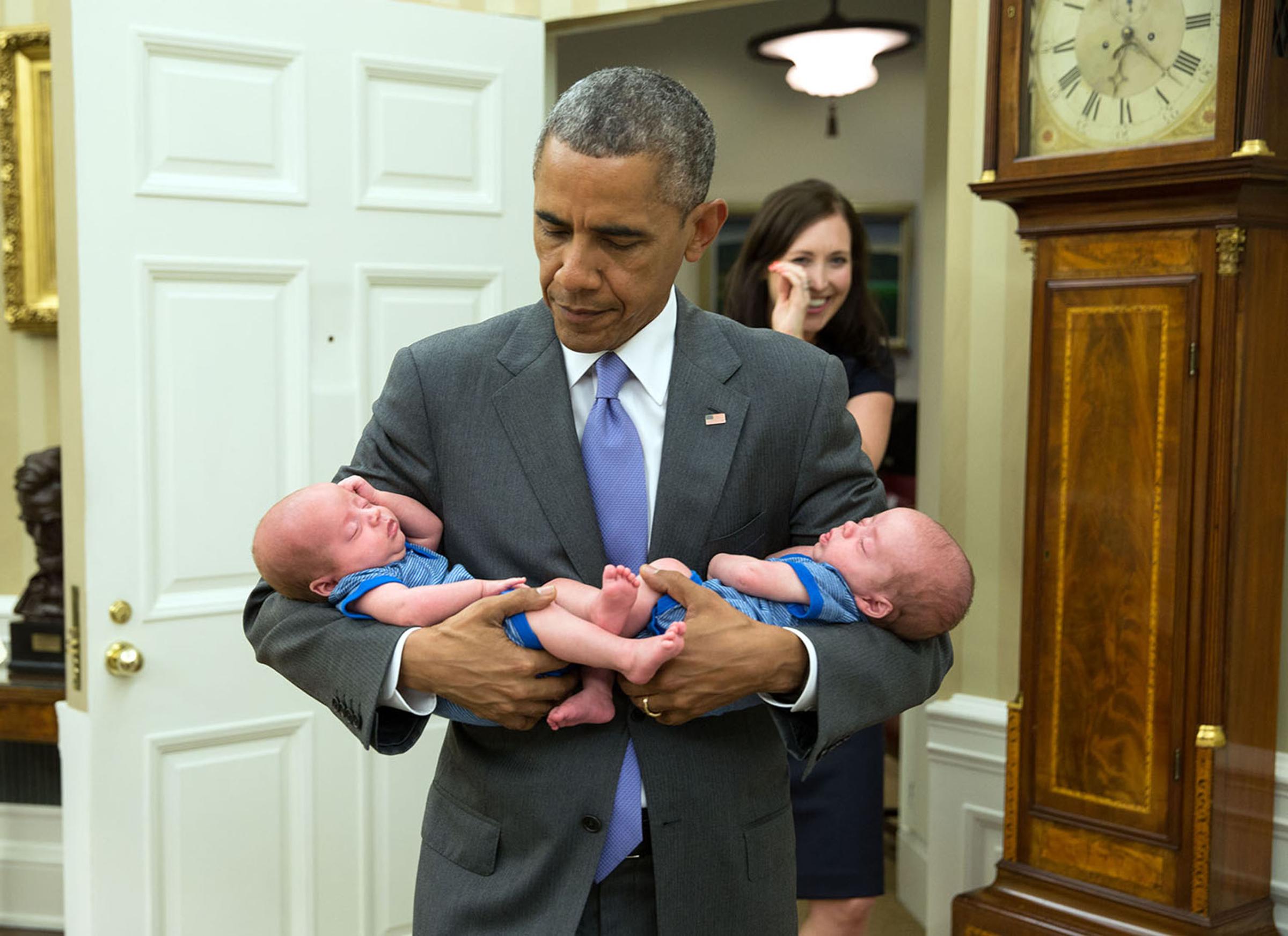 June 17, 2015"The President carries the twin boys of Katie Beirne Fallon, Director of Legislative Affairs, into the Oval Office just a few months after they were born." (Official White House Photo by Pete Souza)This official White House photograph is being made available only for publication by news organizations and/or for personal use printing by the subject(s) of the photograph. The photograph may not be manipulated in any way and may not be used in commercial or political materials, advertisements, emails, products, promotions that in any way suggests approval or endorsement of the President, the First Family, or the White House.