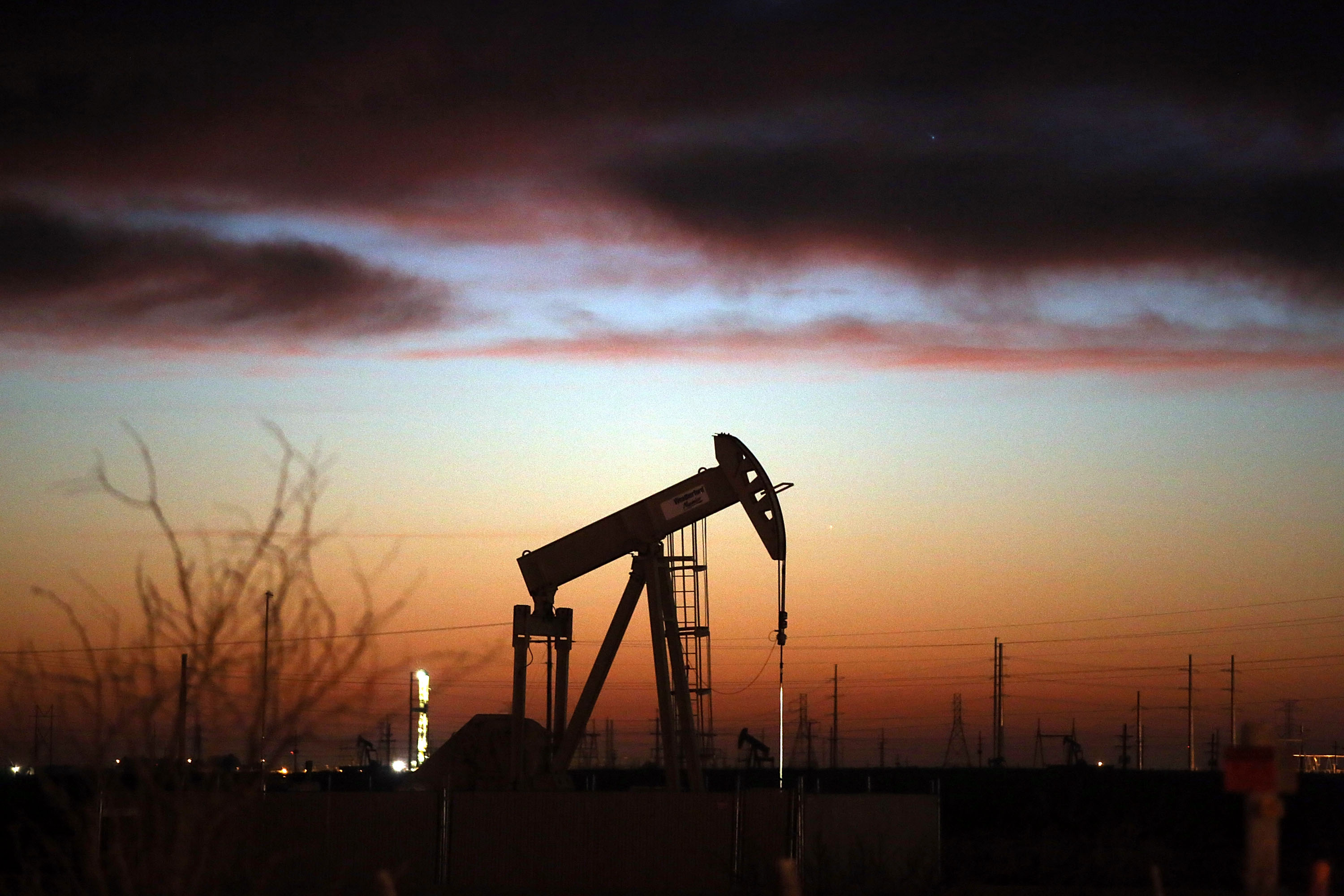 An oil pumpjack works at dawn in the Permian Basin oil field on Jan. 20, 2016 in the oil town of Andrews, TX. (Spencer Platt—Getty Images)
