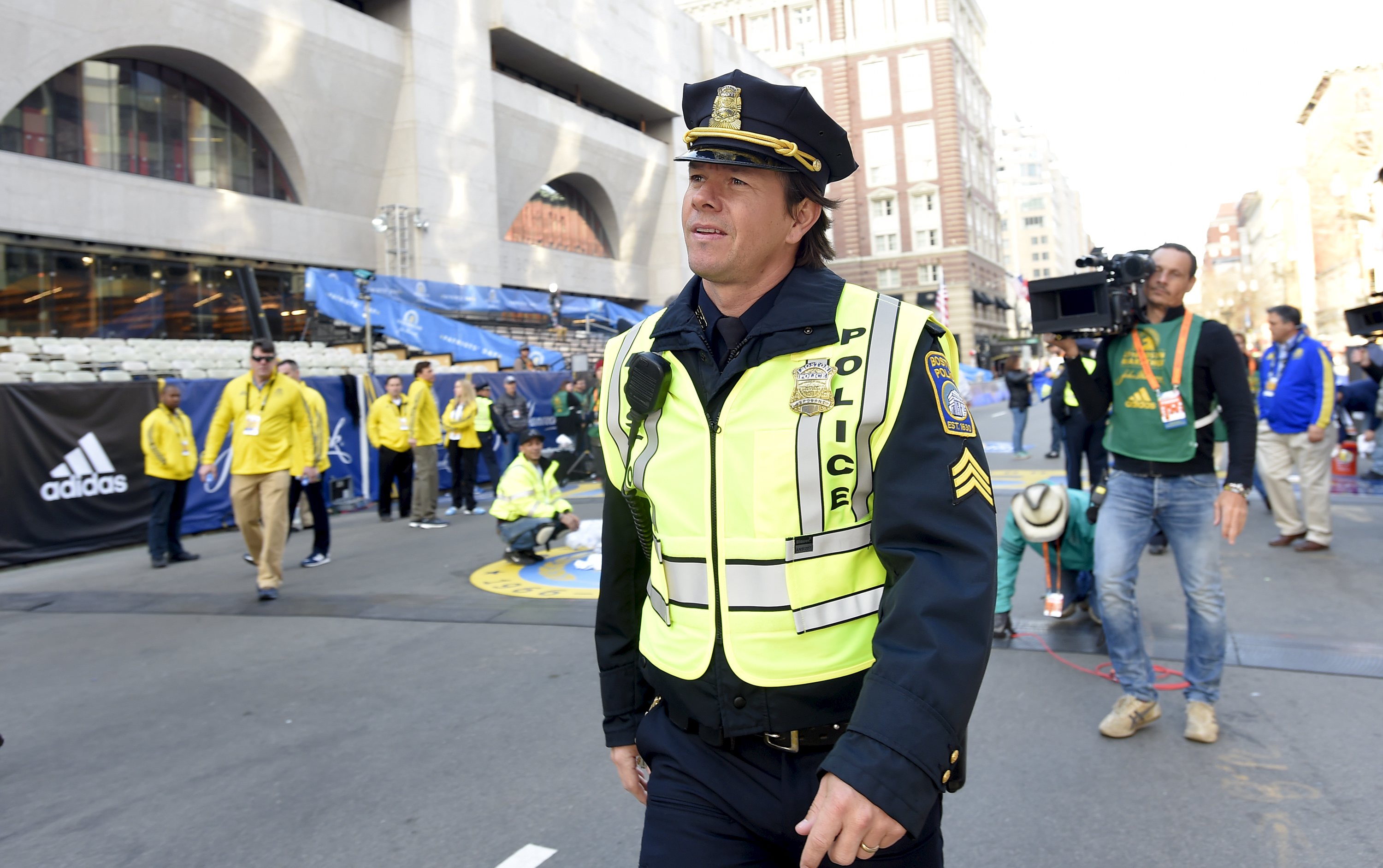 Actor Mark Wahlberg in the role of a Boston police officer prepares to film a scene for the movie "Patriot's Day" at the finish line before the start of the 120th running of the Boston Marathon in Boston