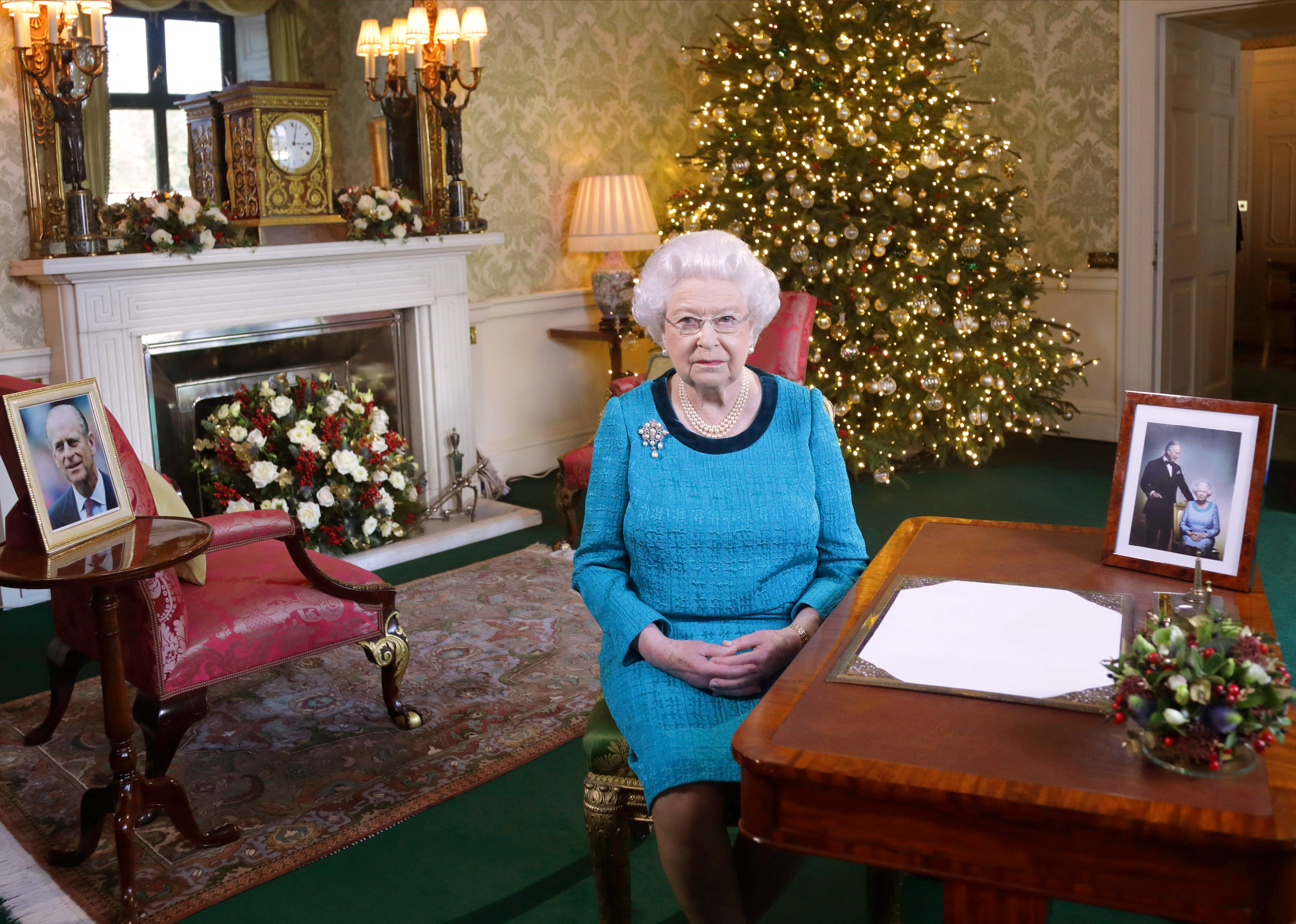 Queen Elizabeth II sits at a desk in the Regency Room after recording her Christmas Day broadcast to the Commonwealth at Buckingham Palace on December 24, 2016 in London, England. (Yui Mok&mdash;WPA Pool/Getty Images)