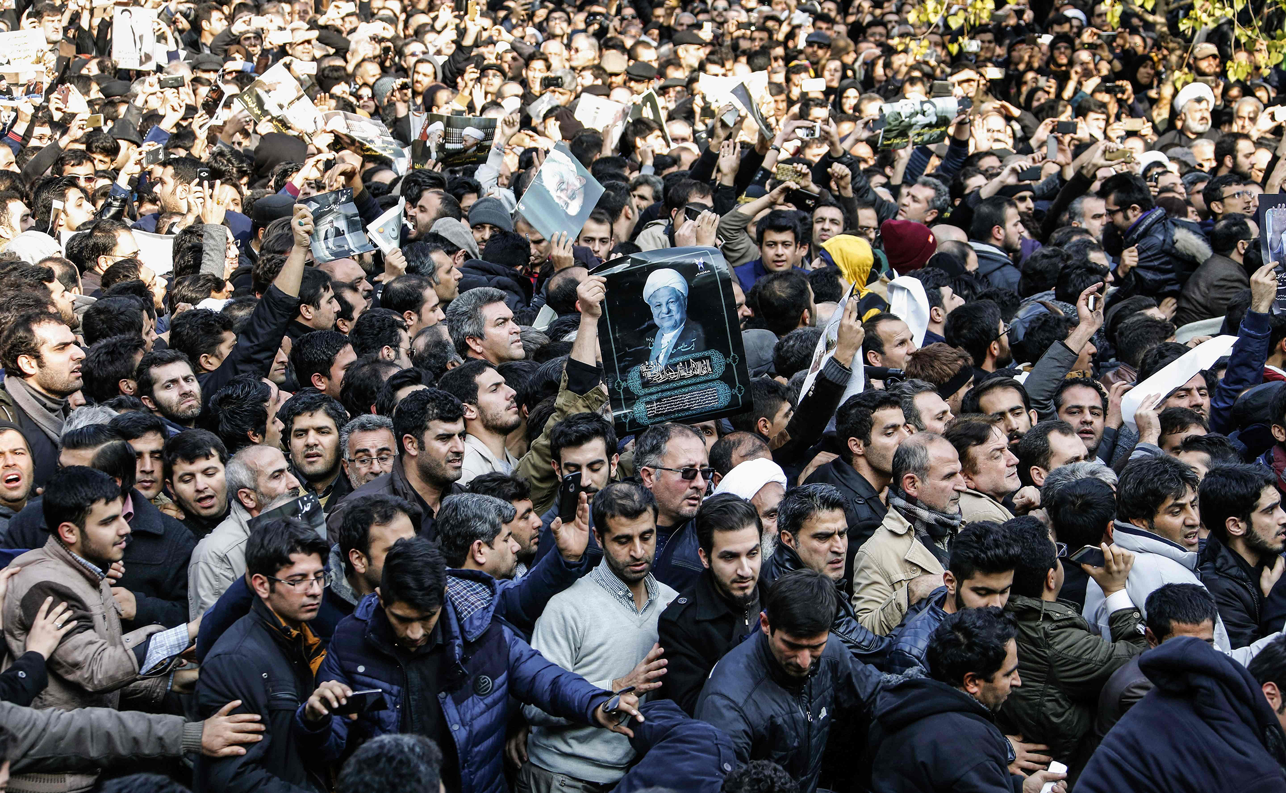 Iranians gather around a hearse carrying the coffin of former President Akbar Hashemi Rafsanjani during his funeral ceremony in Tehran on Jan. 10, 2017.
                      The heavyweight politician will be buried inside the crypt of Ayatollah Ruhollah Khomeini, the leader of Iran's 1979 Islamic revolution, at Khomeini's mausoleum. (Atta Kenare—AFP/Getty Images)