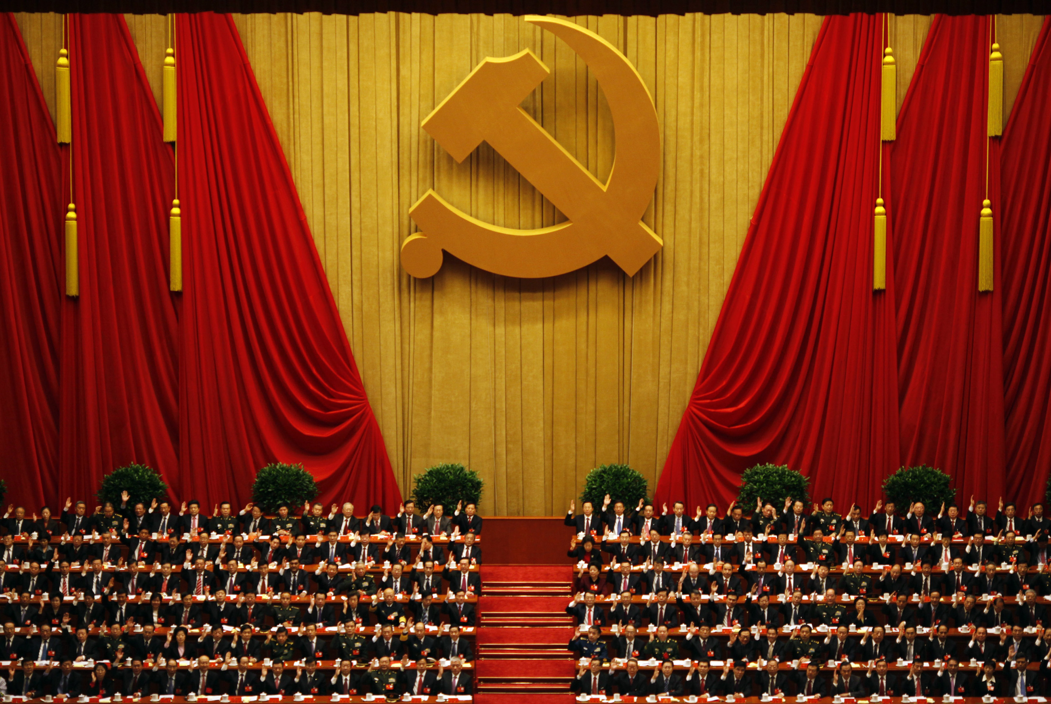 A general view shows delegates raising their hands as they take a vote at the closing session of the 18th National Congress of the Communist Party of China at the Great Hall of the People in Beijing on Nov. 14, 2012 (Carlos Barria —Reuters)