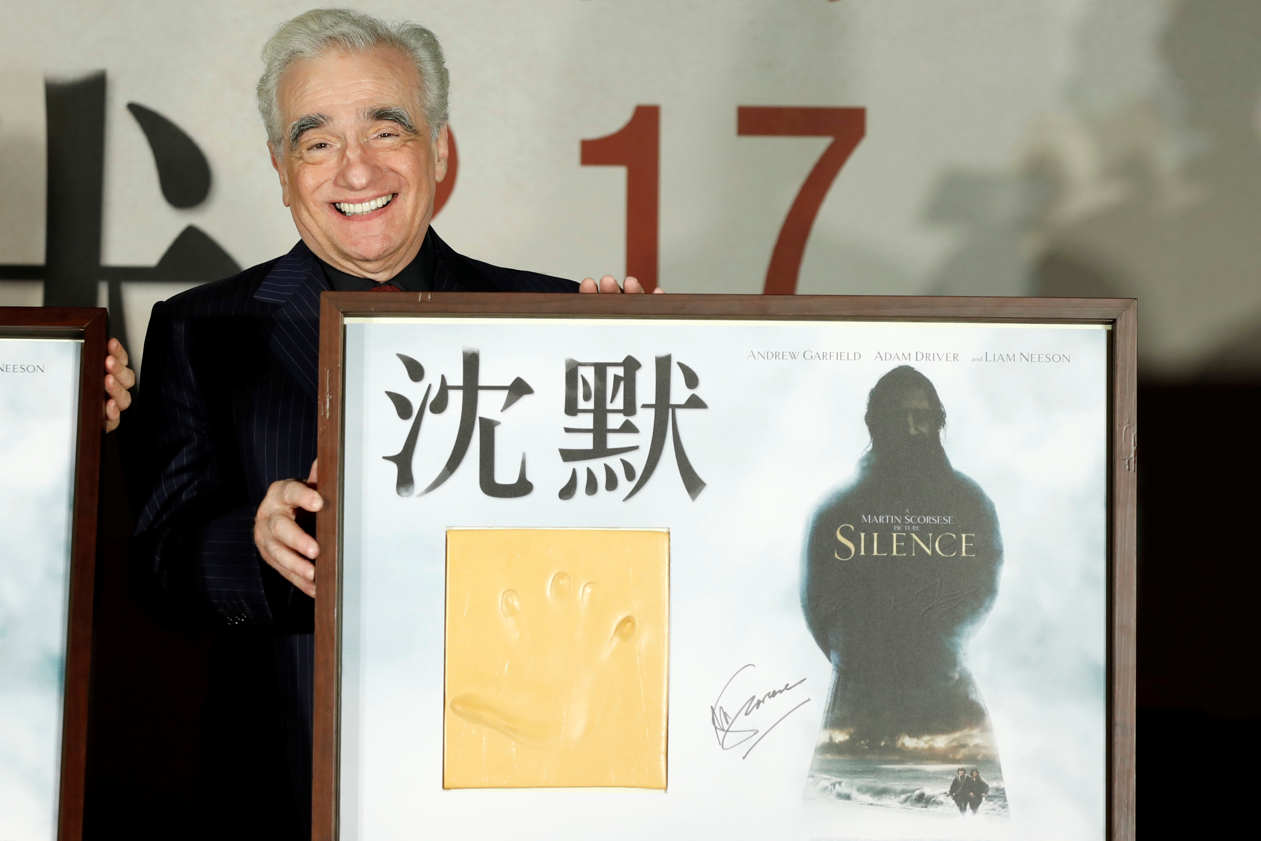 U.S. director Martin Scorsese poses with his handprint during the premiere of "Silence", in Taipei