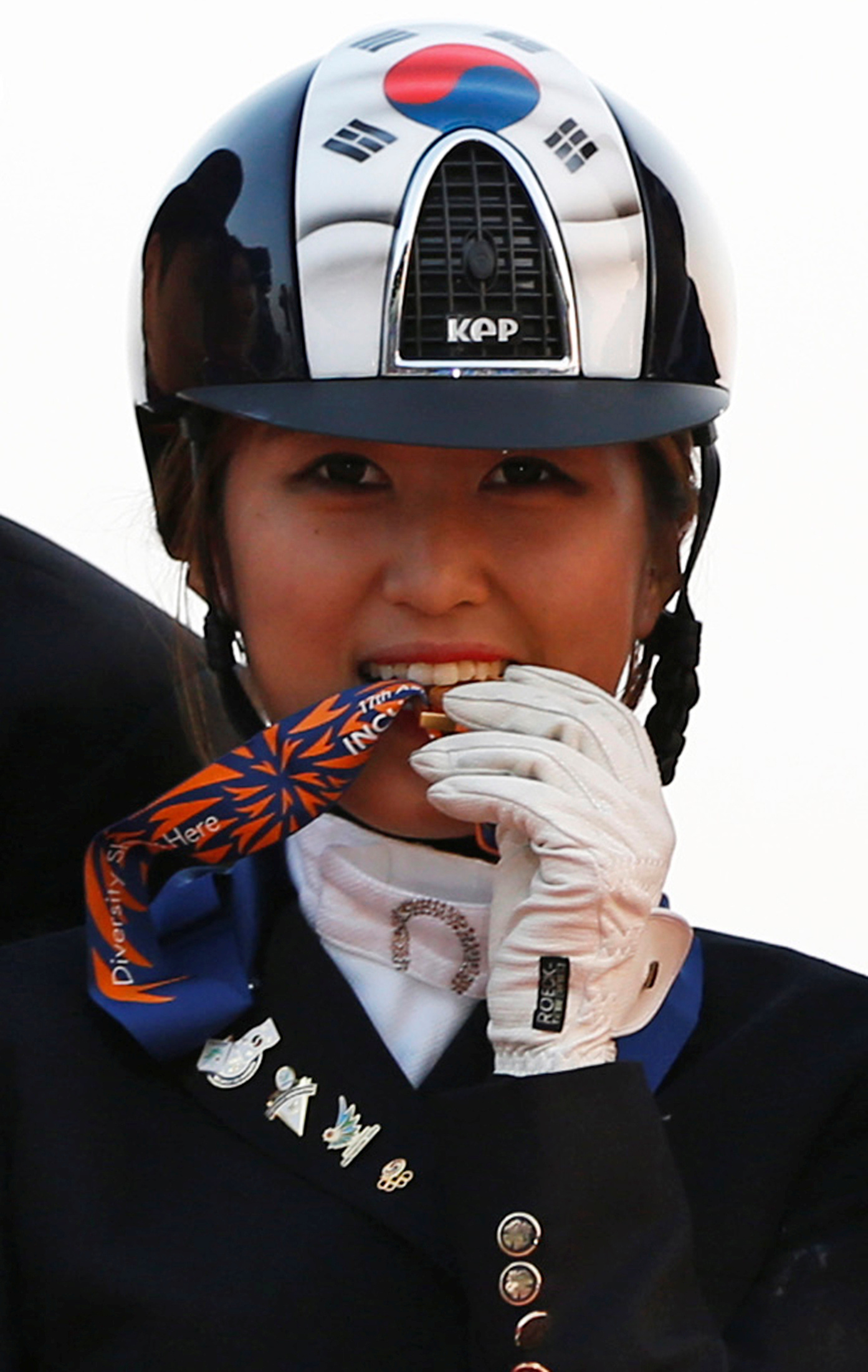 FILE PHOTO: South Korea's Chung Yoo-ra poses after winning the equestrian Dressage Team competition during the 17th Asian Games in Incheon