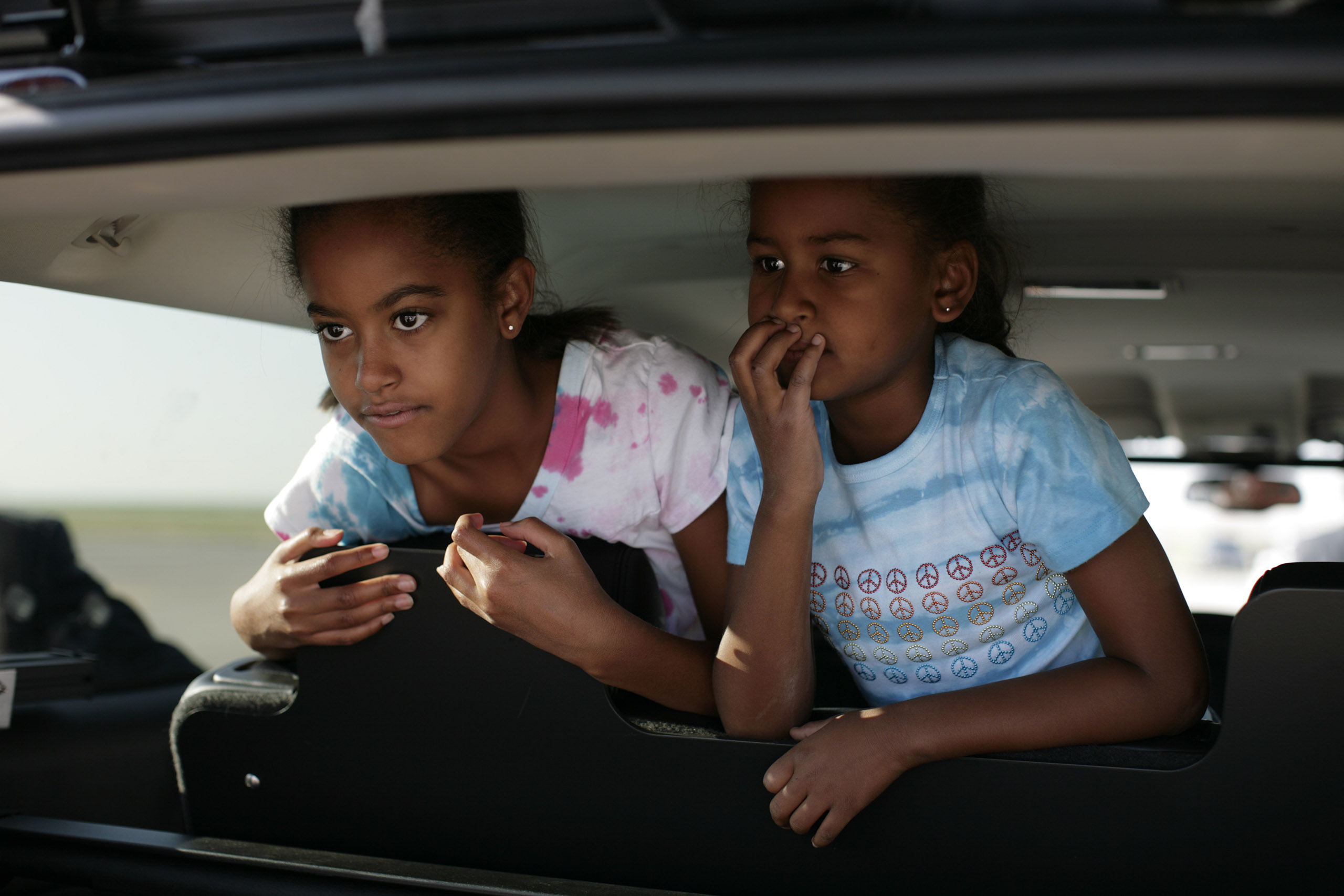 Malia and Sasha Obama see their parents off at the airport in Denver, CO, on Aug. 29, 2008.