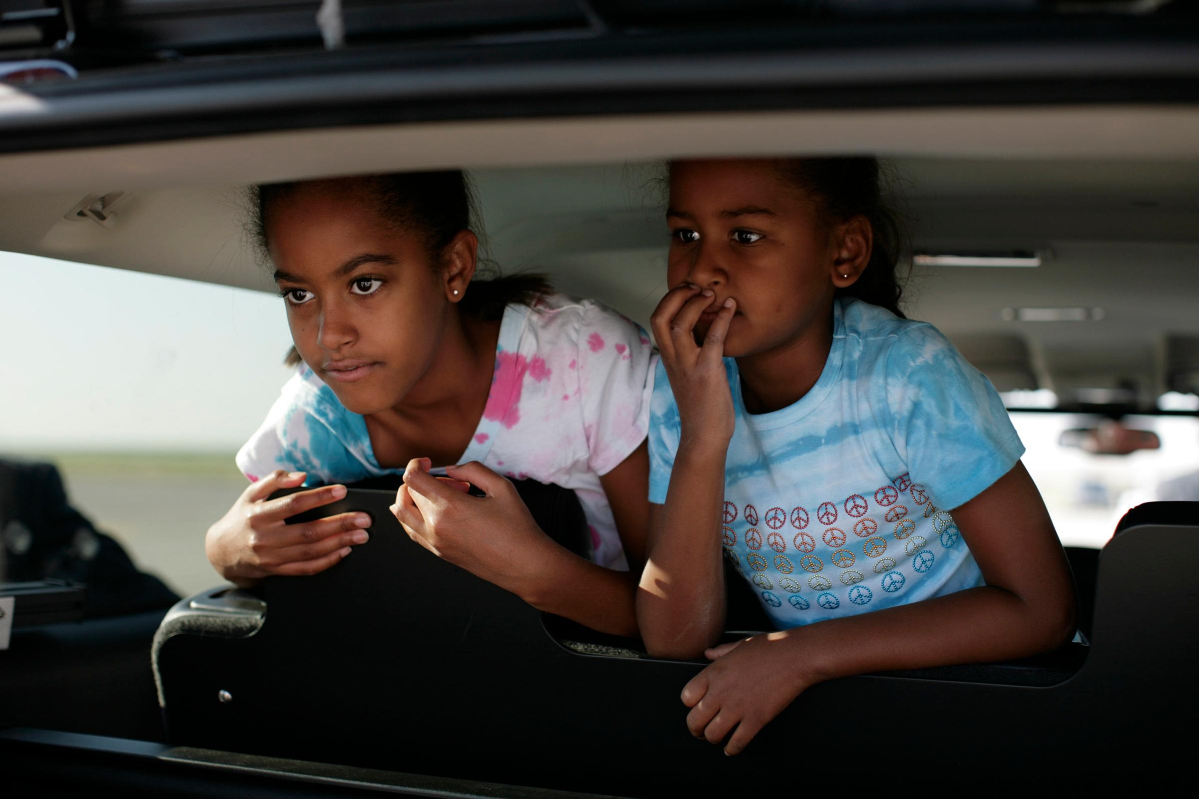 Malia, left, and Sasha Obama at the airport to see their parents off. The Obamas and Bidens were flying from Denver, CO  to Pennsylvania to begin a three day bus tour in PA and OH. 20080829. Photo by Callie Shell/Aurora for Time.