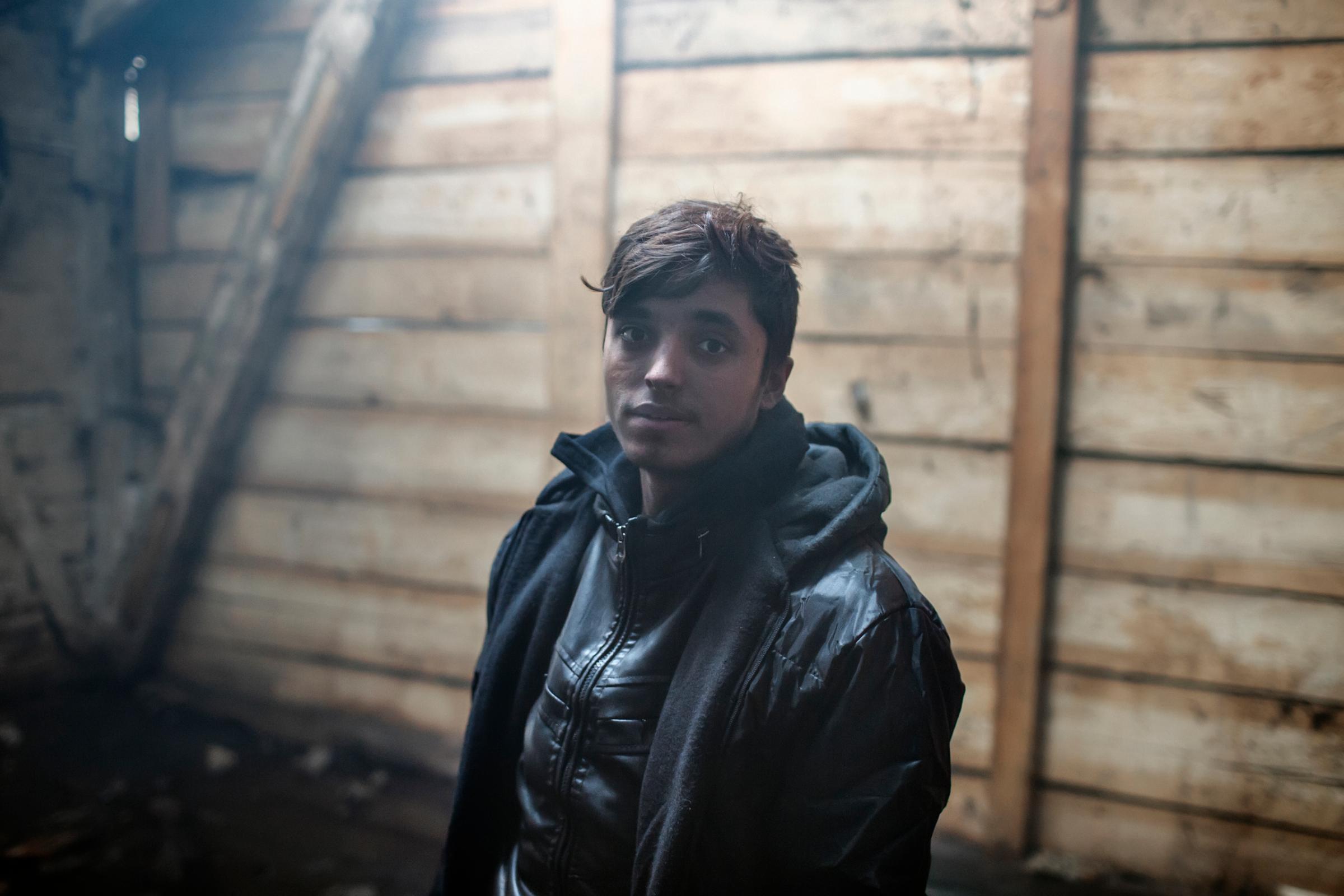 Asmatullah , 14, an unaccompanied minor from Pakistan living in an abandoned building near the train station in Belgrade.