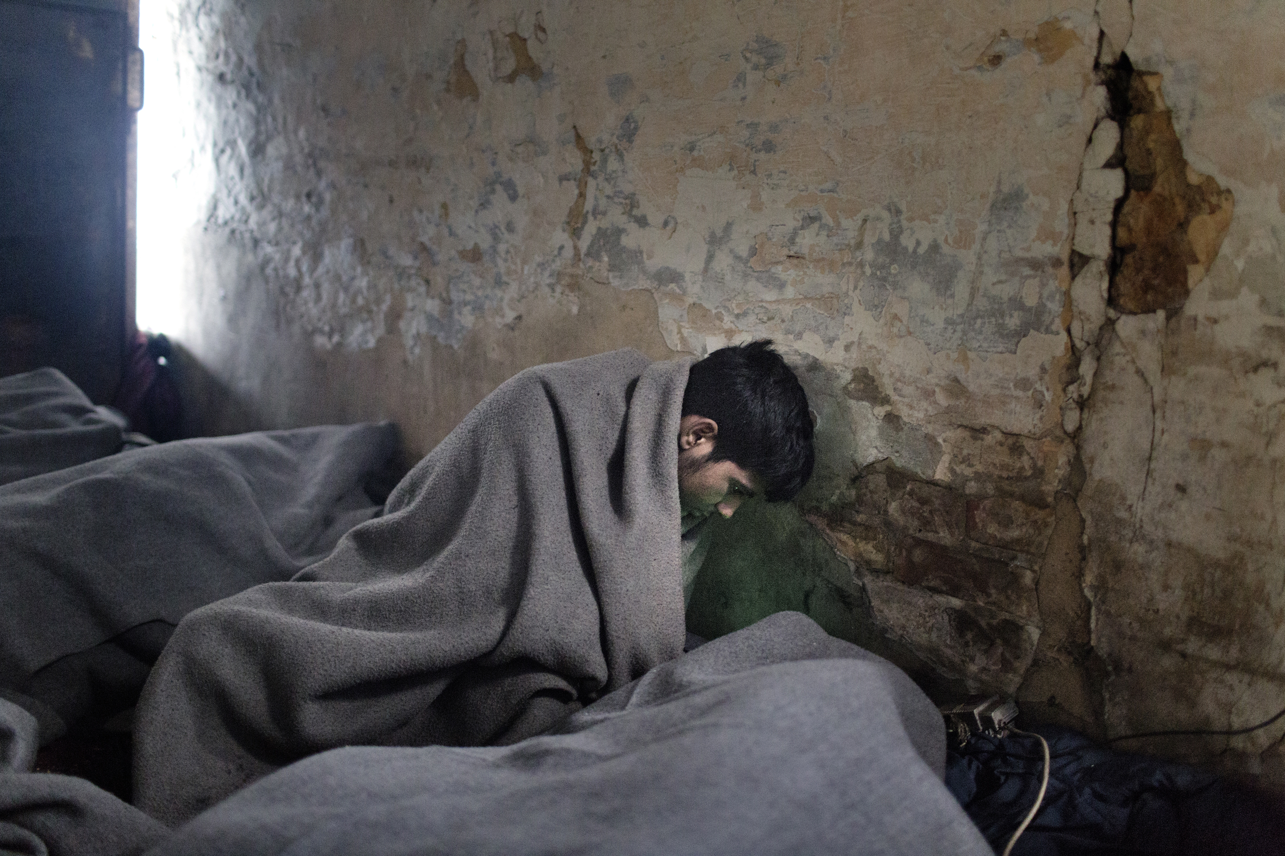 A group of unaccompanied minors from Afghanistan wait in an abandoned warehouse in Belgrade, Serbia. They hope smugglers will help them reach Europe, Jan 13, 2017.