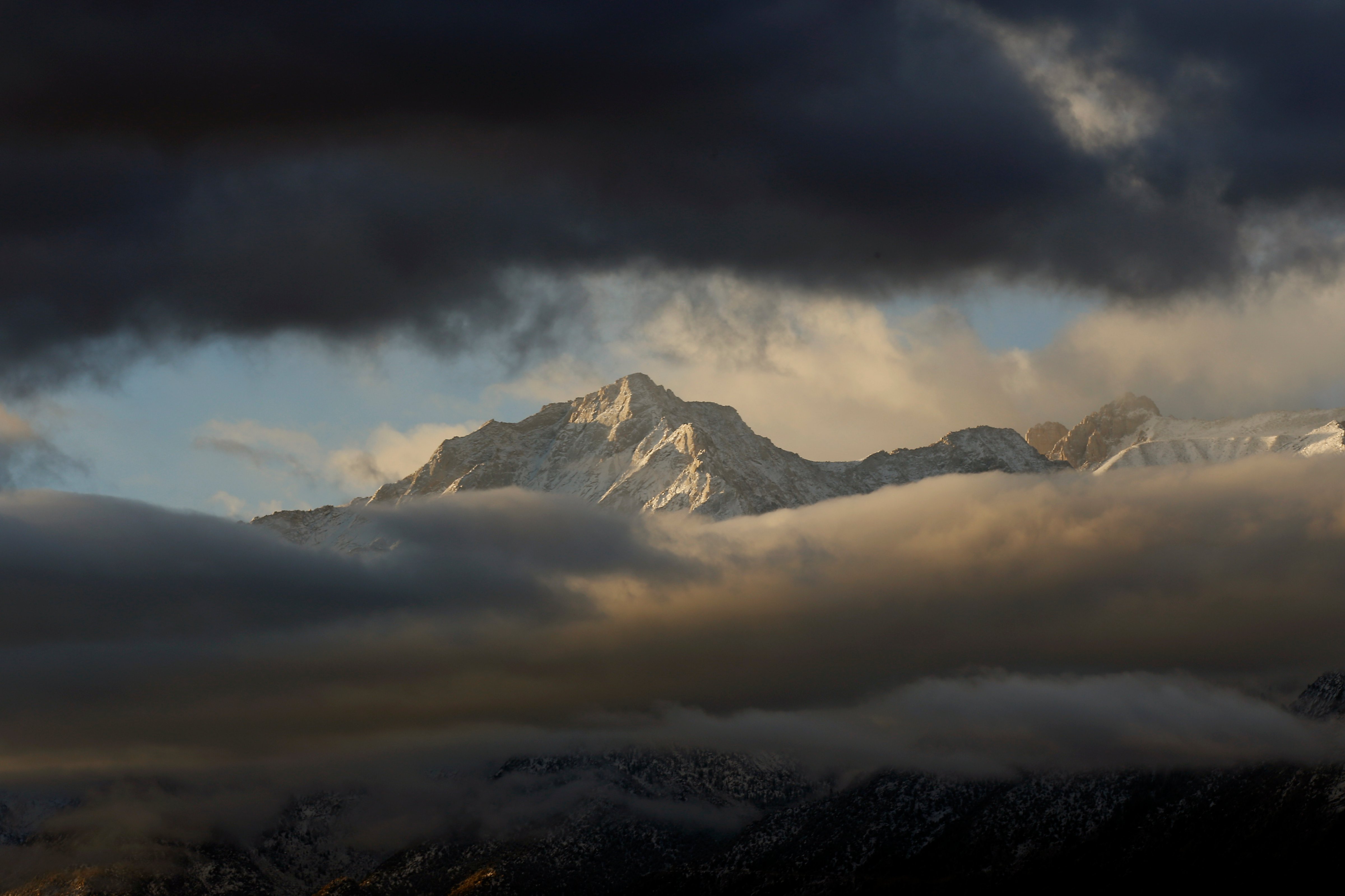 Snow is visible through the clouds on the Eastern Sierra from Lone Pine, Calif. overnight Nov. 21, 2016. (Francine Orr—LA Times via Getty Images)