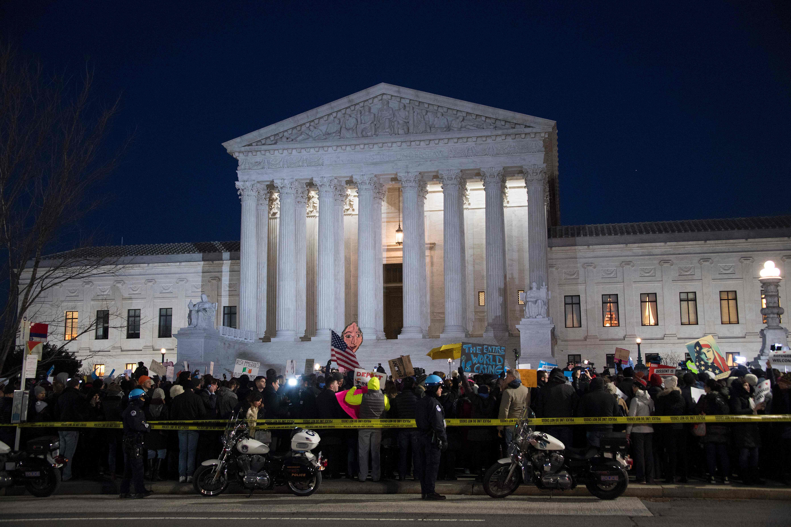 Demonstrators gather outside the US Supreme Court demanding US President Donald Trump reverse hateful anti-refugee and anti-immigration executive orders in Washington on Jan. 30, 2017. (Jim Watson—AFP/Getty Images)