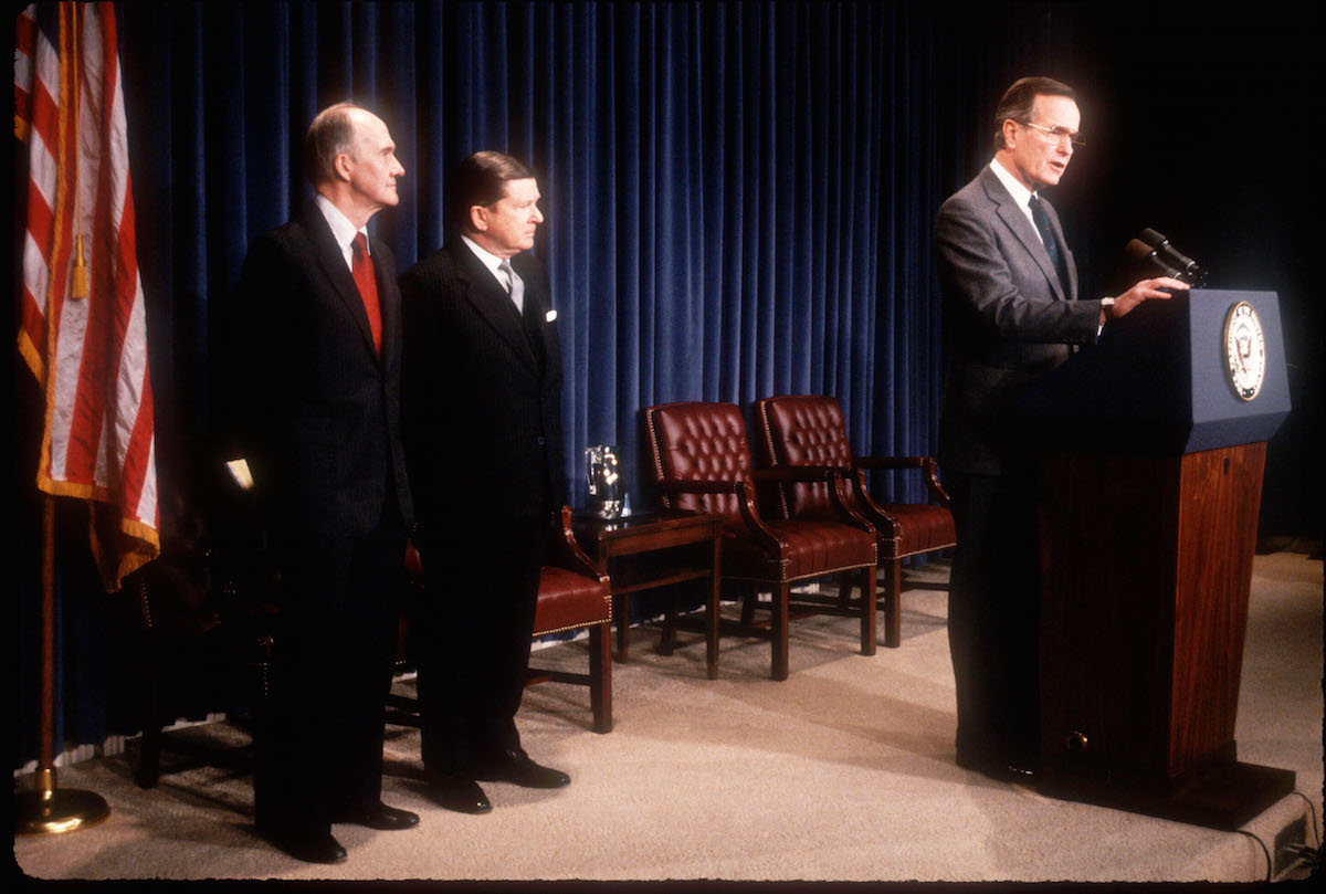National Security Advisor Brent Scowcroft stands next to John Tower as Vice President George Bush announces the former Senator's nomination for Secretary of Defense on Dec. 16, 1988 in Washington, D.C. (Diana Walker—Hulton Archive/Getty Images)