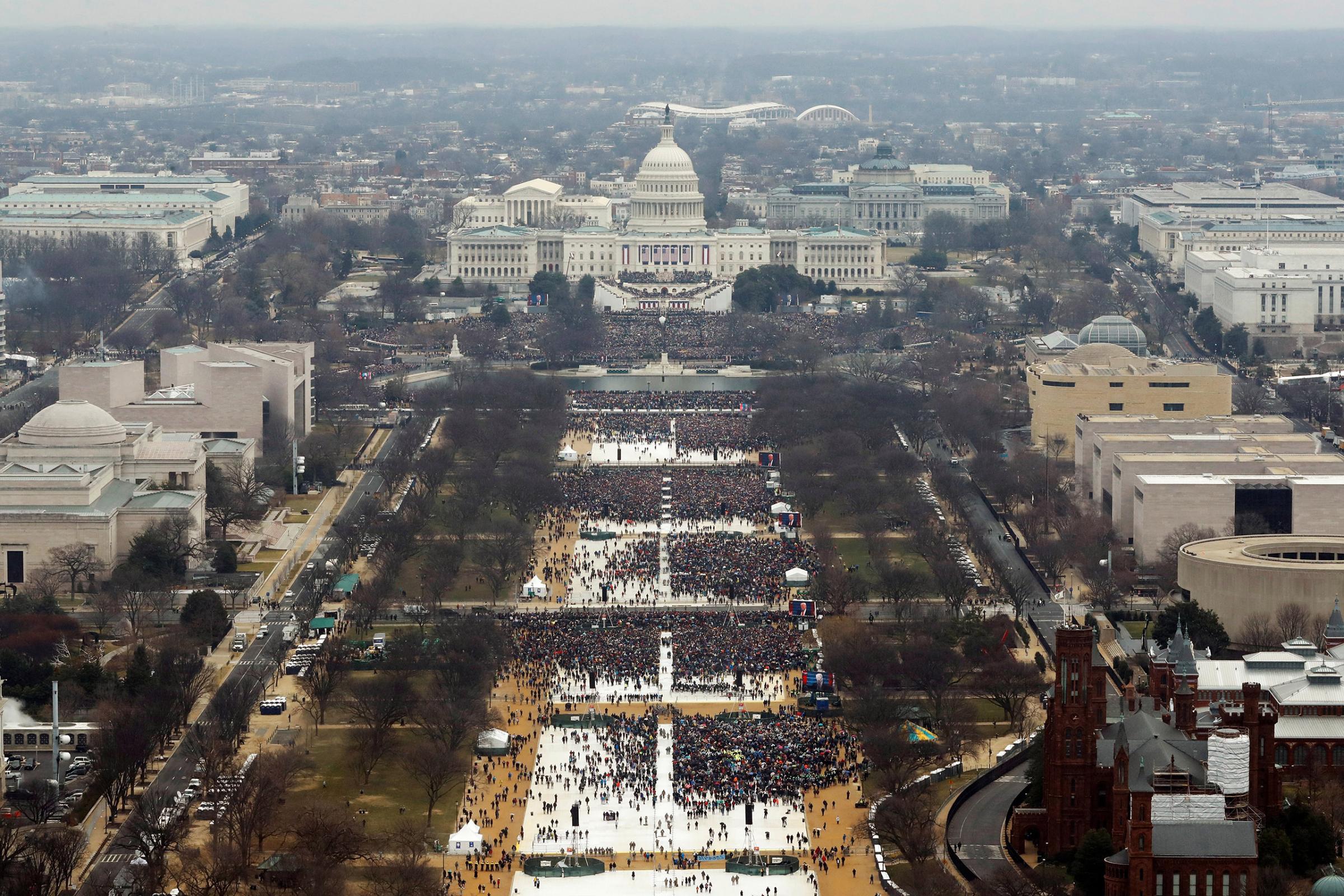 Attendees line the Mall as they watch ceremonies to swear in Donald Trump on Inauguration Day on Jan. 20, 2017 in Washington.