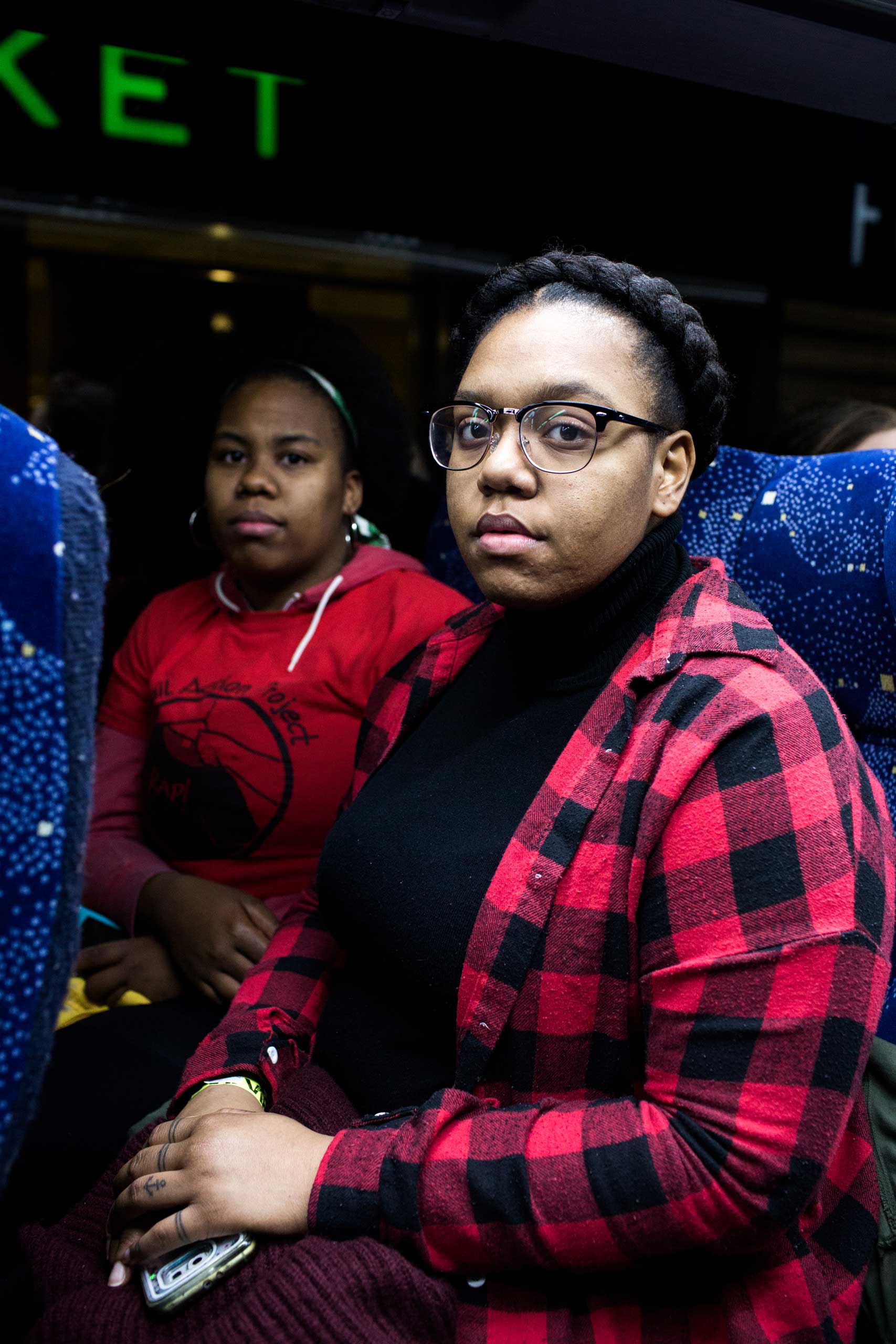 1:40 AM: Lysondra Webb, 25, (right) and Sade Dixon, 25, (left) pose for a portrait on the bus. As a member of a marginalized community I'm obligated to be a representative," Lysondra tells me. "That person who's going to be sitting in the White House and all his cronies are not for me." "My grandparents protested with Malcolm X for me to have a better life. It's my duty to continue the fight and its' sad that I have to but I will fight and speak up for my brothers and my community," says Dixon.