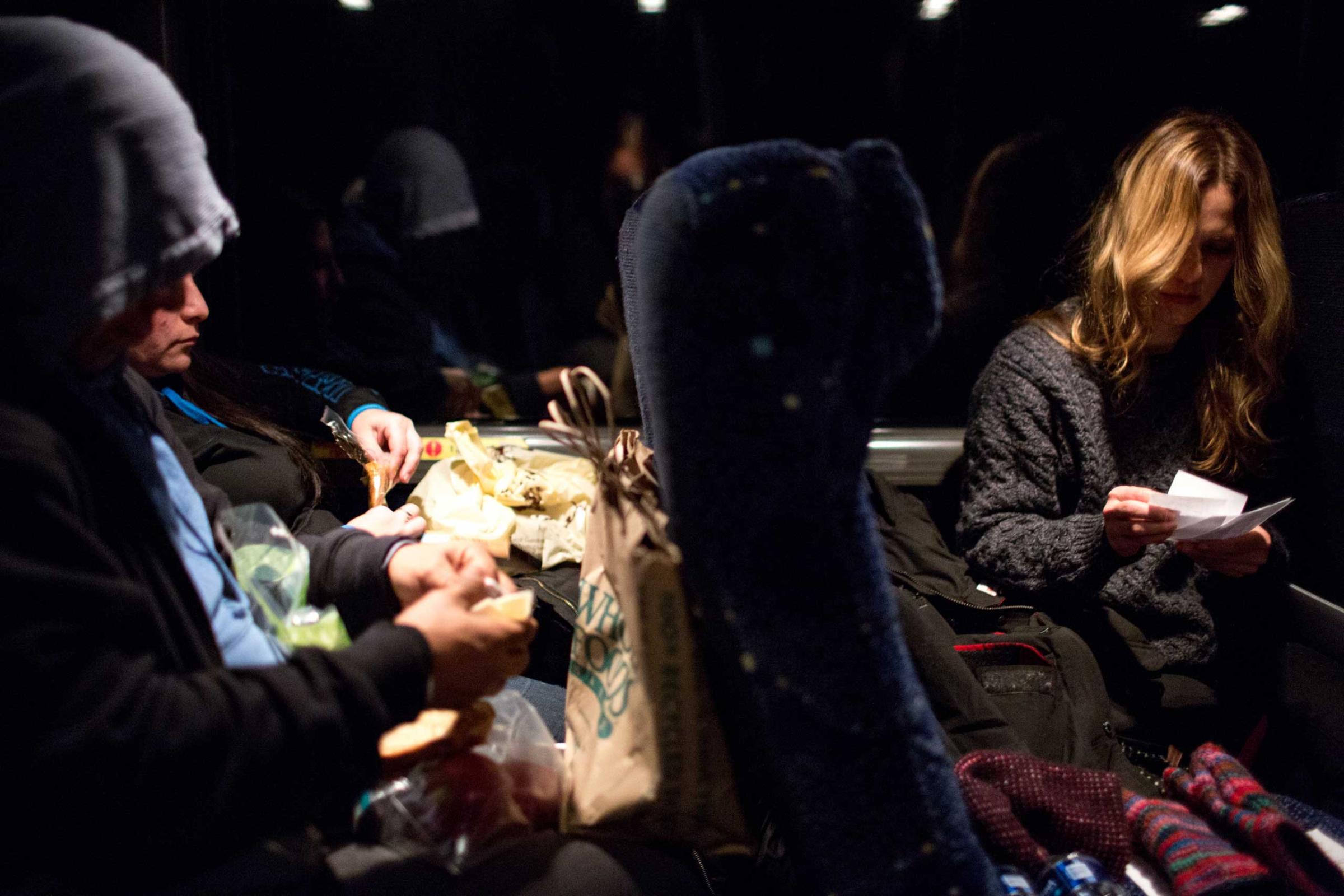 5:28 AM: Anna plans her protest sign while other activists prepare their lunches around 5am as the bus approaches D.C.