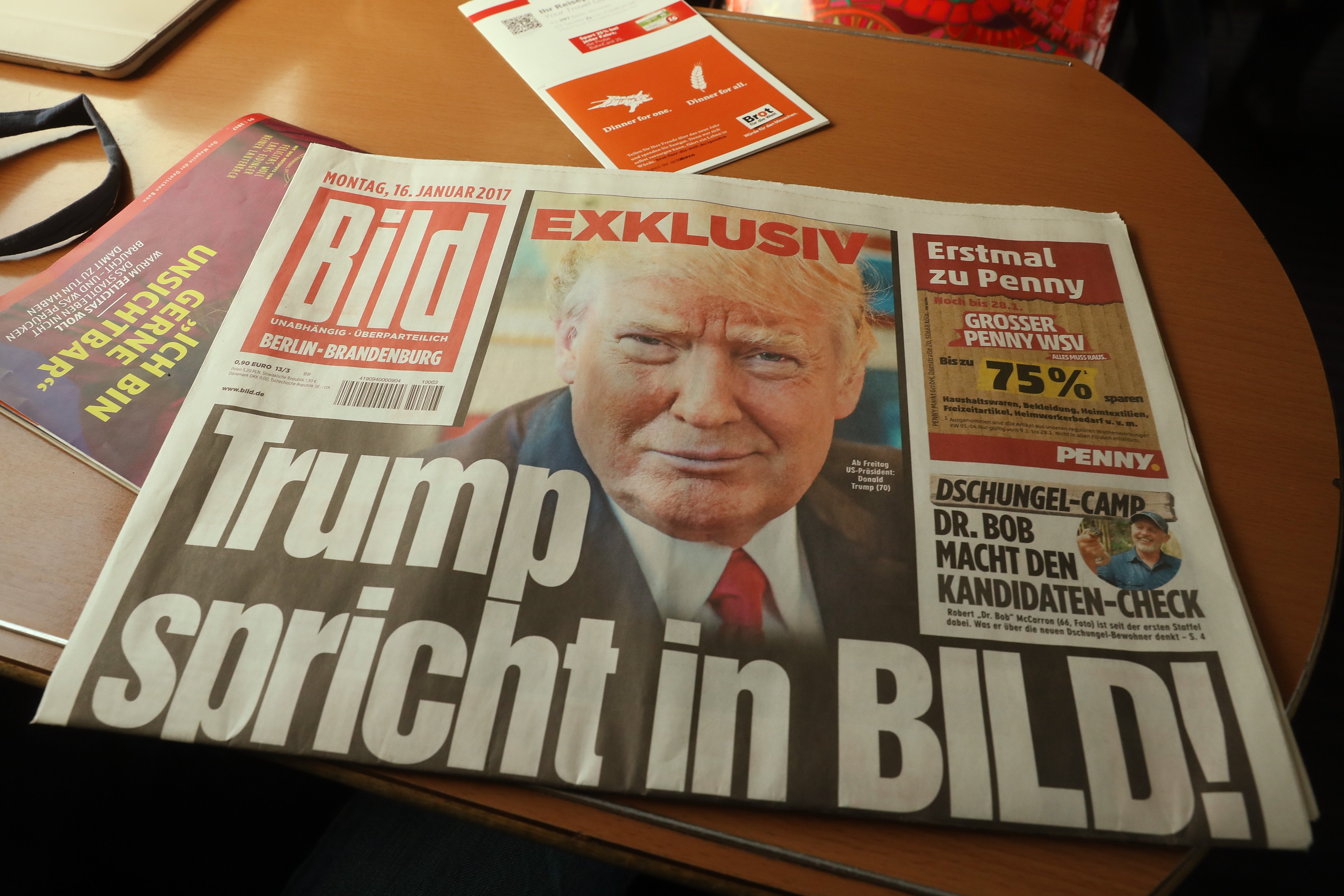 In this photo illustration a copy of the January 16 issue of German tabloid Bild Zeitung that features an exclusive interview with U.S. President-elect Donald Trump lies on a table in a train on January 16, 2017 in Berlin, Germany.