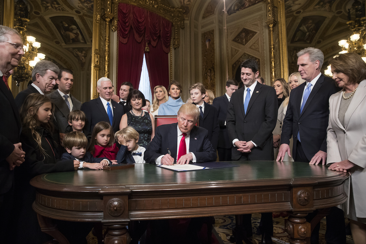 U.S. President Donald Trump, center, prepares to formally sign his cabinet nominations into law with U.S. House Speaker Paul Ryan, a Republican from Wisconsin, from second left, House Majority Leader Kevin McCarthy, a Republican from California, and House Minority Leader Nancy Pelosi, a Democrat from California, during the 58th presidential inauguration in Washington, D.C., on Jan. 20, 2017. (J. Scott Applewhite—Bloomberg/Getty Images)