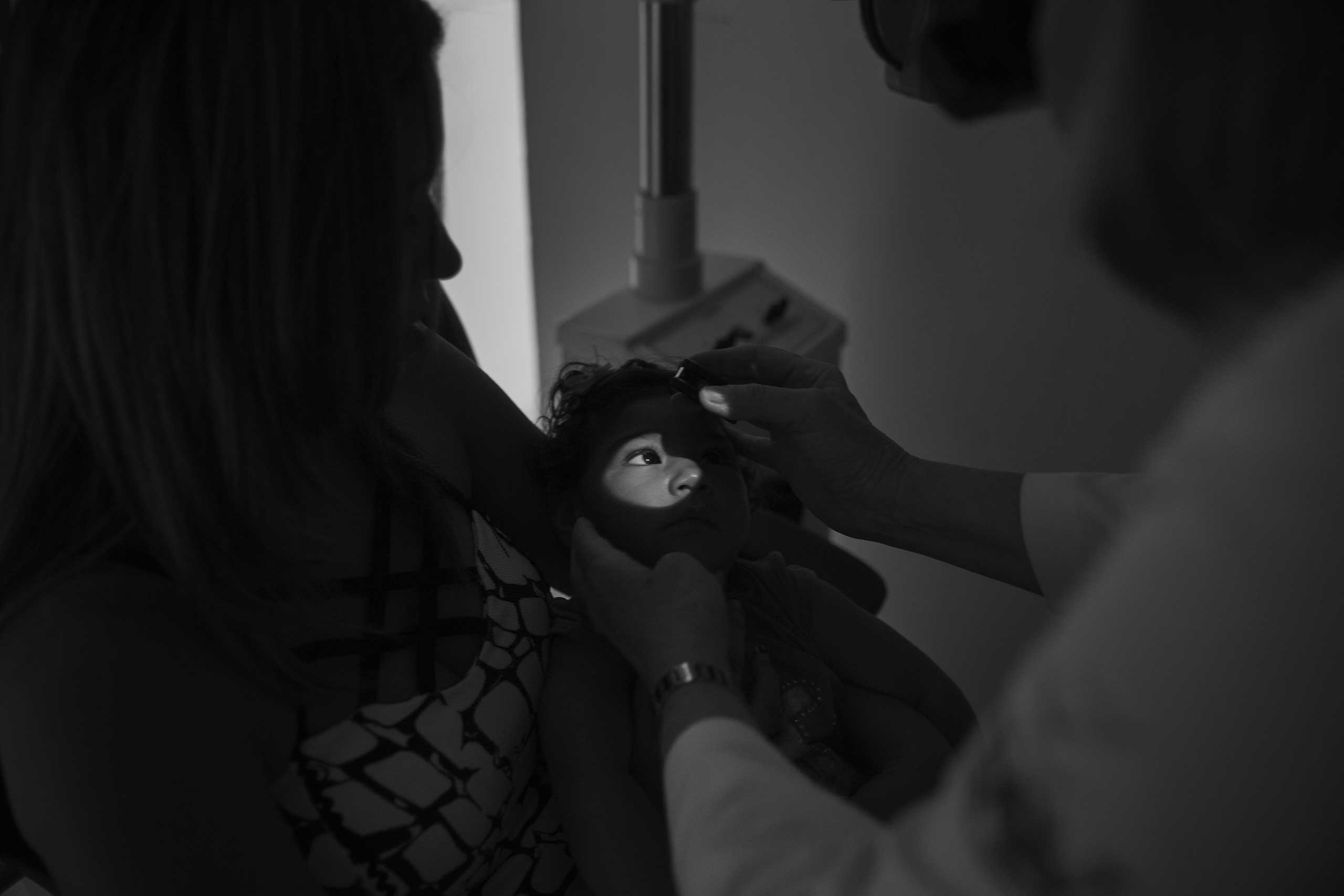 Ophthalmologist Liana Ventura examines Maria Alice, 11 months old, born with microcephaly caused by the Zika virus, while she sits in the lap of her mother, Helen Naiara, 22, at the Altino Ventura Foundation in Recife. According to doctor Liana Ventura, 40 percent of children with suspected microcephaly have ocular lesions, especially in the retina and optic nerve, and 6 percent have a hearing deficit.