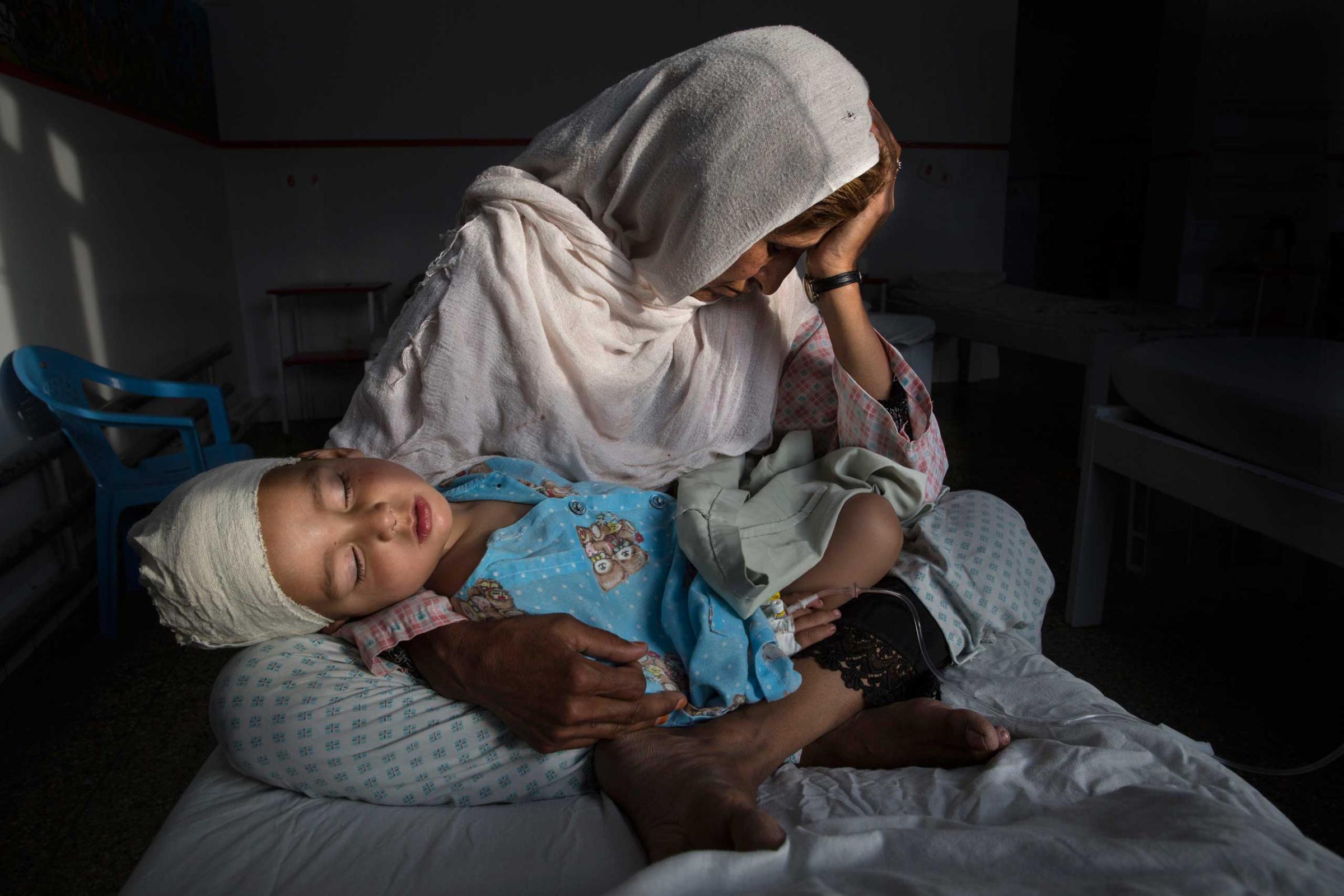KABUL, AFGHANISTAN -MARCH 29, 2016: A the Emergency hospital Najiba holds her nephew Shabir, age 2, who was injured from a bomb blast which killed his sister in Kabul on March 29, 2016. Najiba had to stay with the children as their mother buried her daughter.In 2016 marked another milestone in its 15-year engagement in Afghanistan. Despite billions of dollars spent by the international community to stabilize the country, Afghanistan has seen little improvement in terms of overall stability and human security. The situation on the ground for Afghans continues to be grave. Security for the Afghan people has also deteriorated in large swaths of the country, further complicating humanitarian response. Afghan civilians are at greater risk today than at any time since Taliban rule. According to UN statistics, in the first half of 2016 at least 1,600 people had died, and more than 3,500 people were injured, a 4 per cent increase in overall civilian causalities compared to the same period last year. The upsurge in violence has had devastating consequences for civilians, with suicide bombings and targeted attacks by the Taliban and other insurgents causing 70 percent of all civilian casualties.
