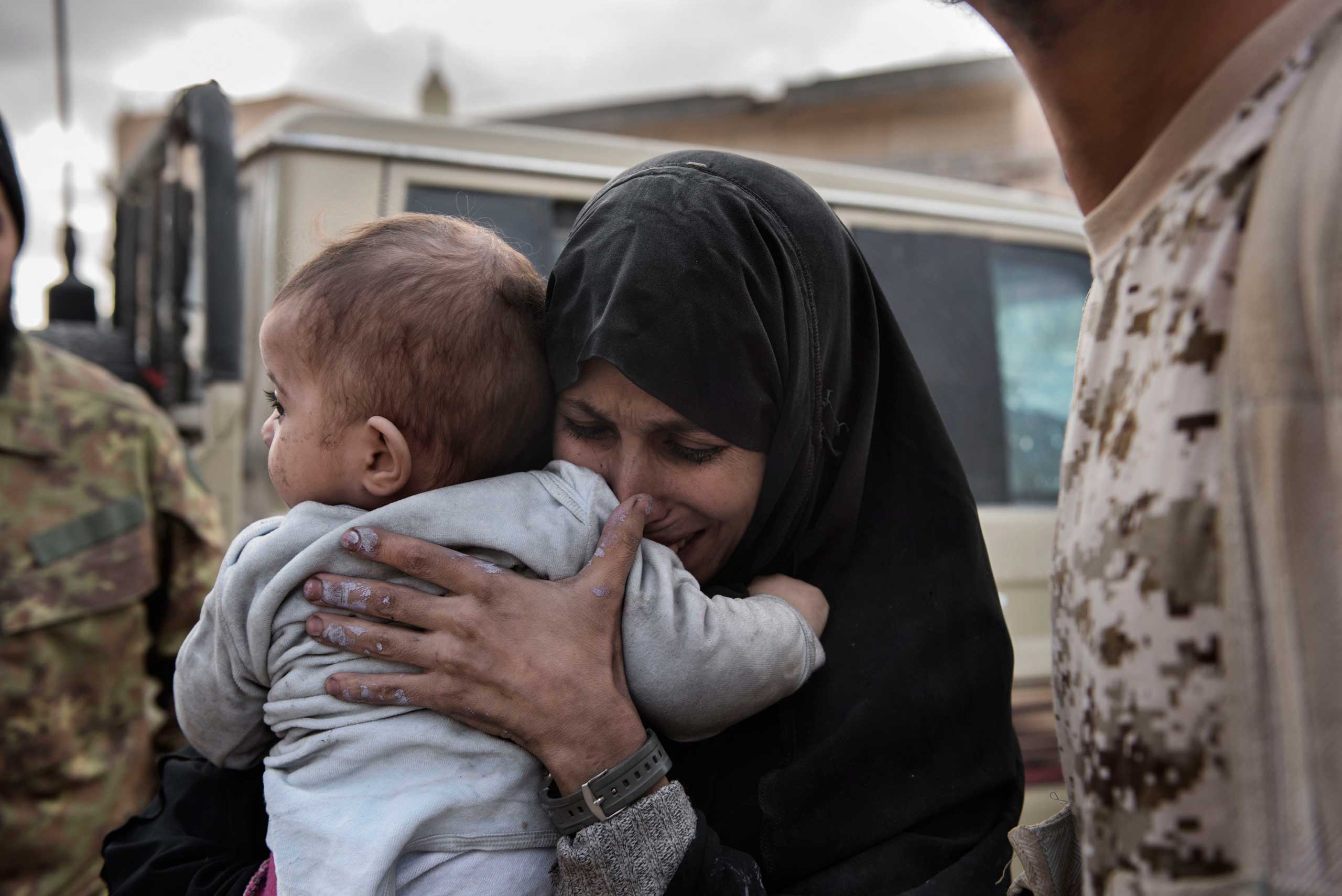 A woman and a child, allegedly IS family members, are seen after fighters of the Libyan forces affiliated to the Tripoli government took them out of the fighting area in Al Jiza neighbourhood  in Sirte on Dec. 1, 2016.