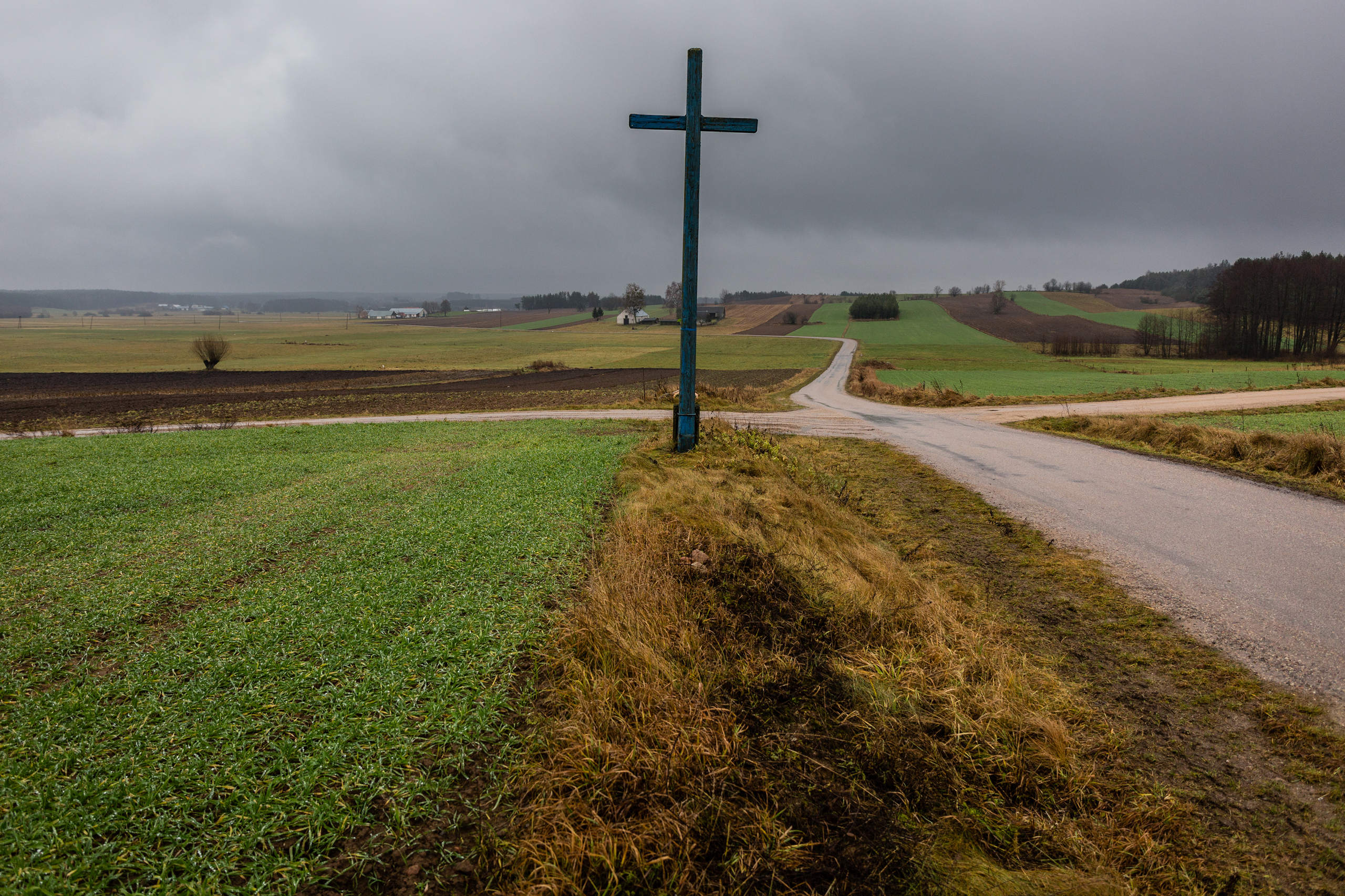 A cross at an intersection at the border between Poland and Belarus. 
                              NATO is committed to defending  NATO member states in the region from possible Russian agession.